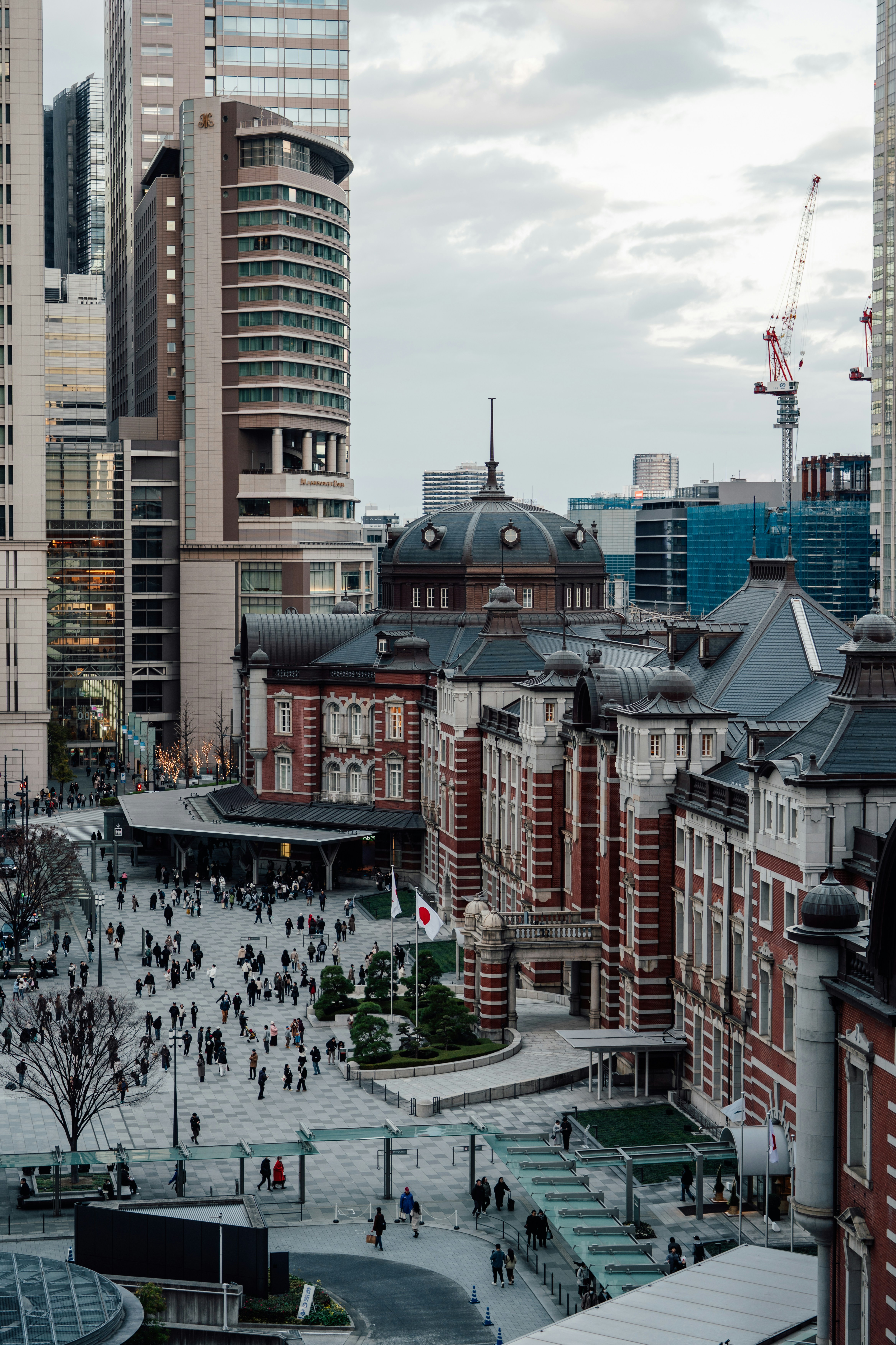 Busy street in front of historic red brick building