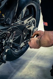 Mechanic working on a motorcycle chain
