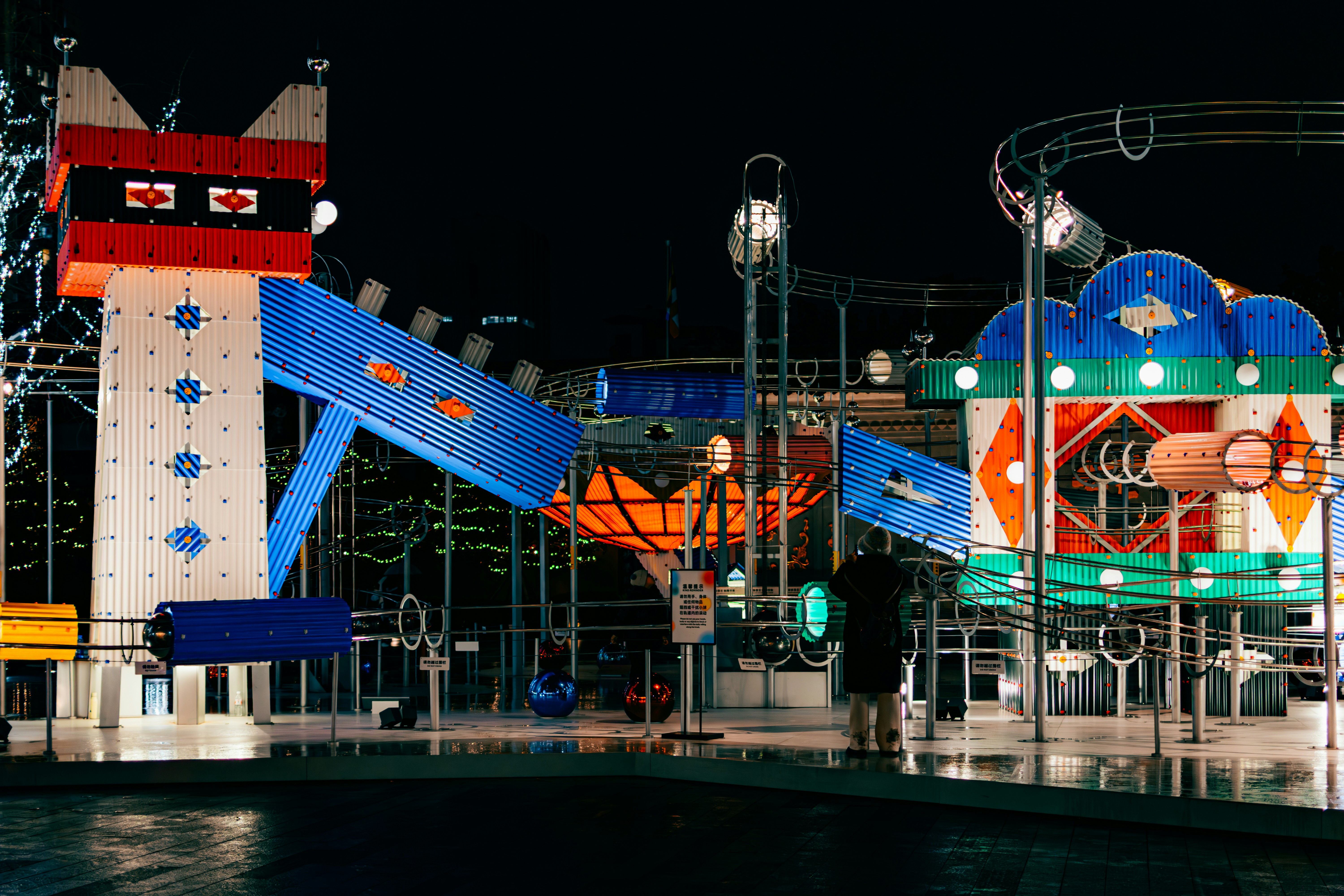 Amusement park rides at night with colorful lights