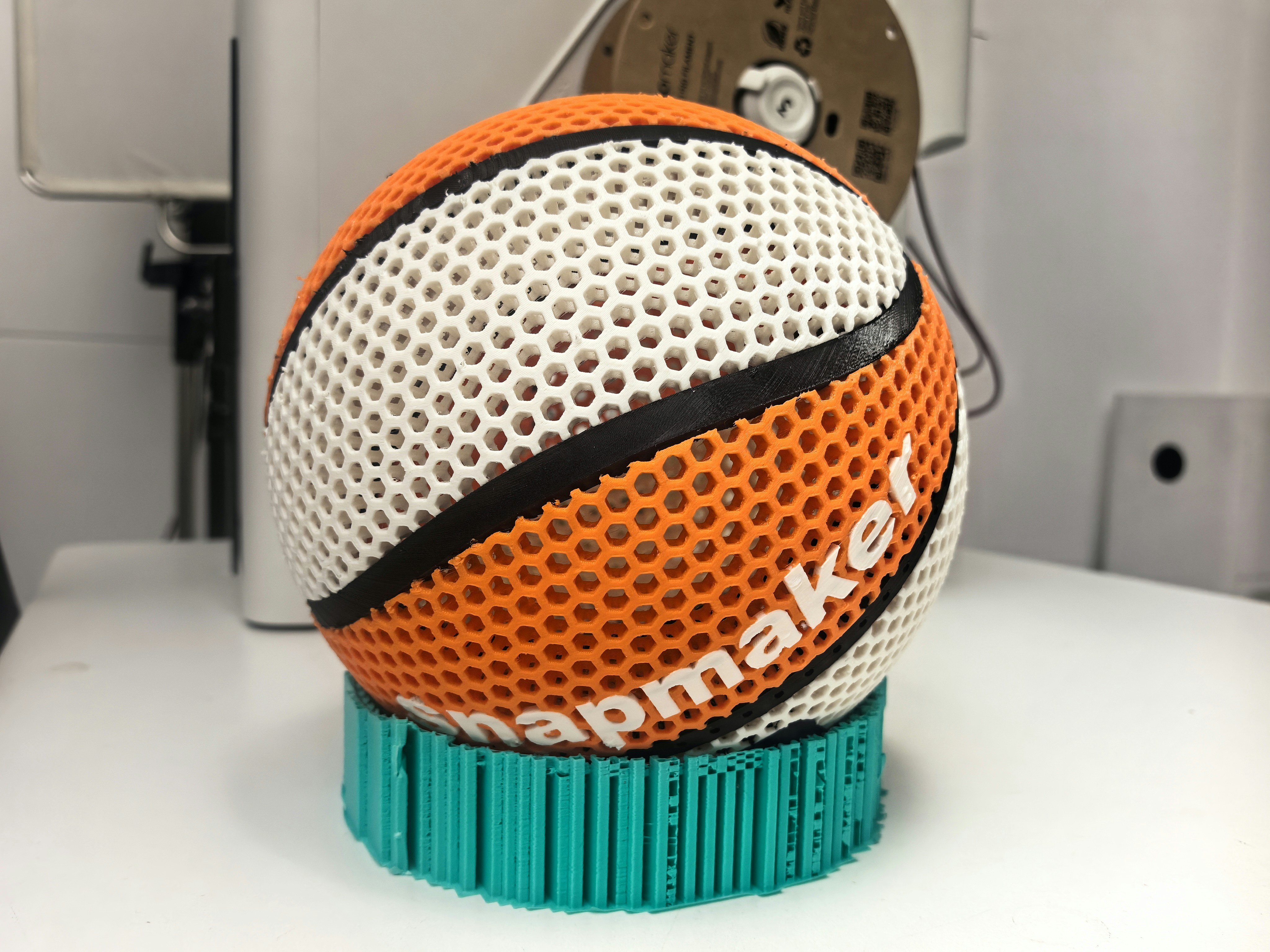 Basketball with "snapmaker" text on stand