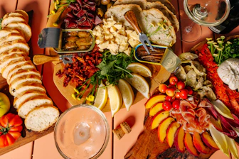 A colorful charcuterie board with various meats and cheeses.