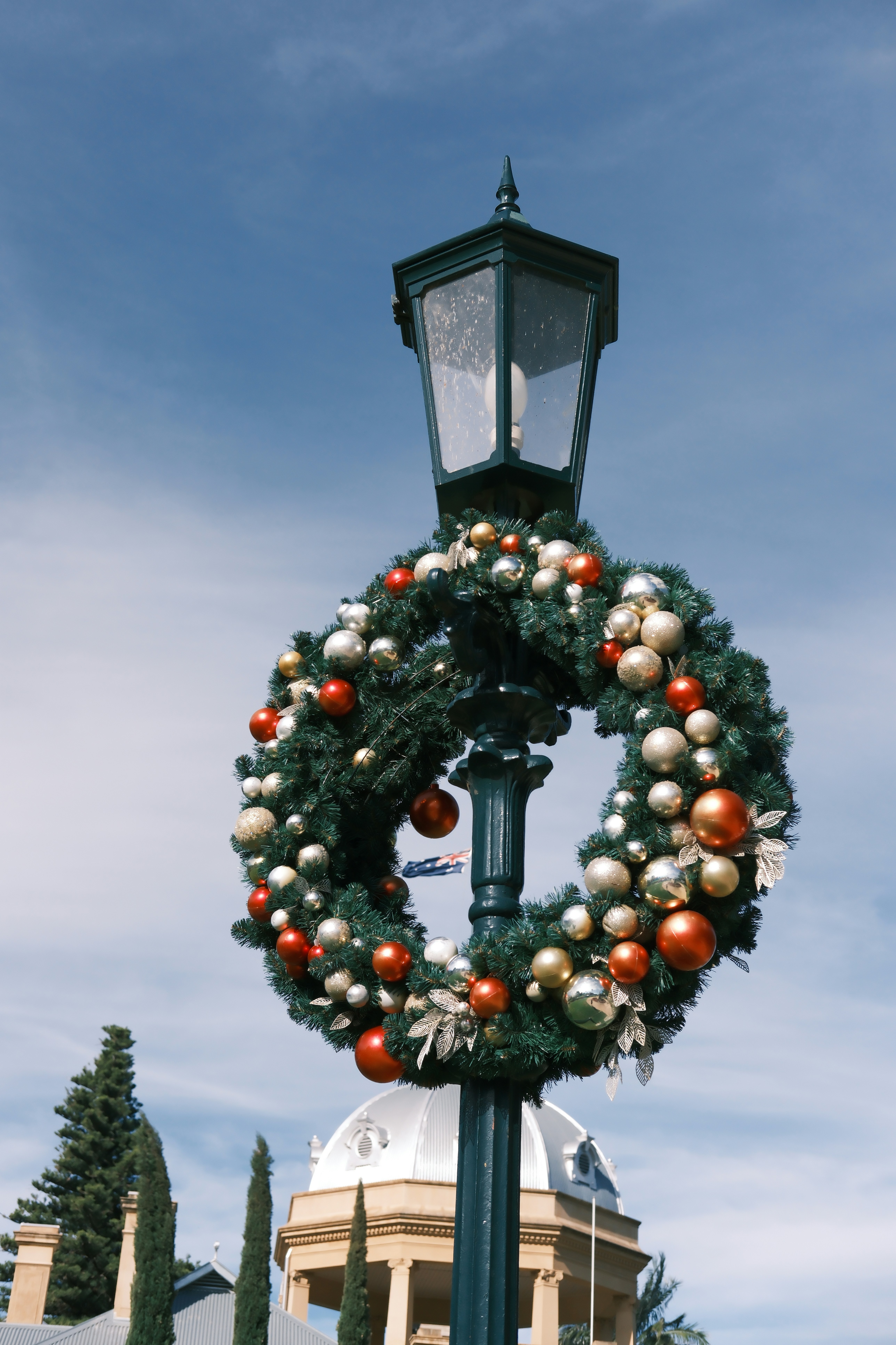 Christmas wreath with ornaments on a lamppost