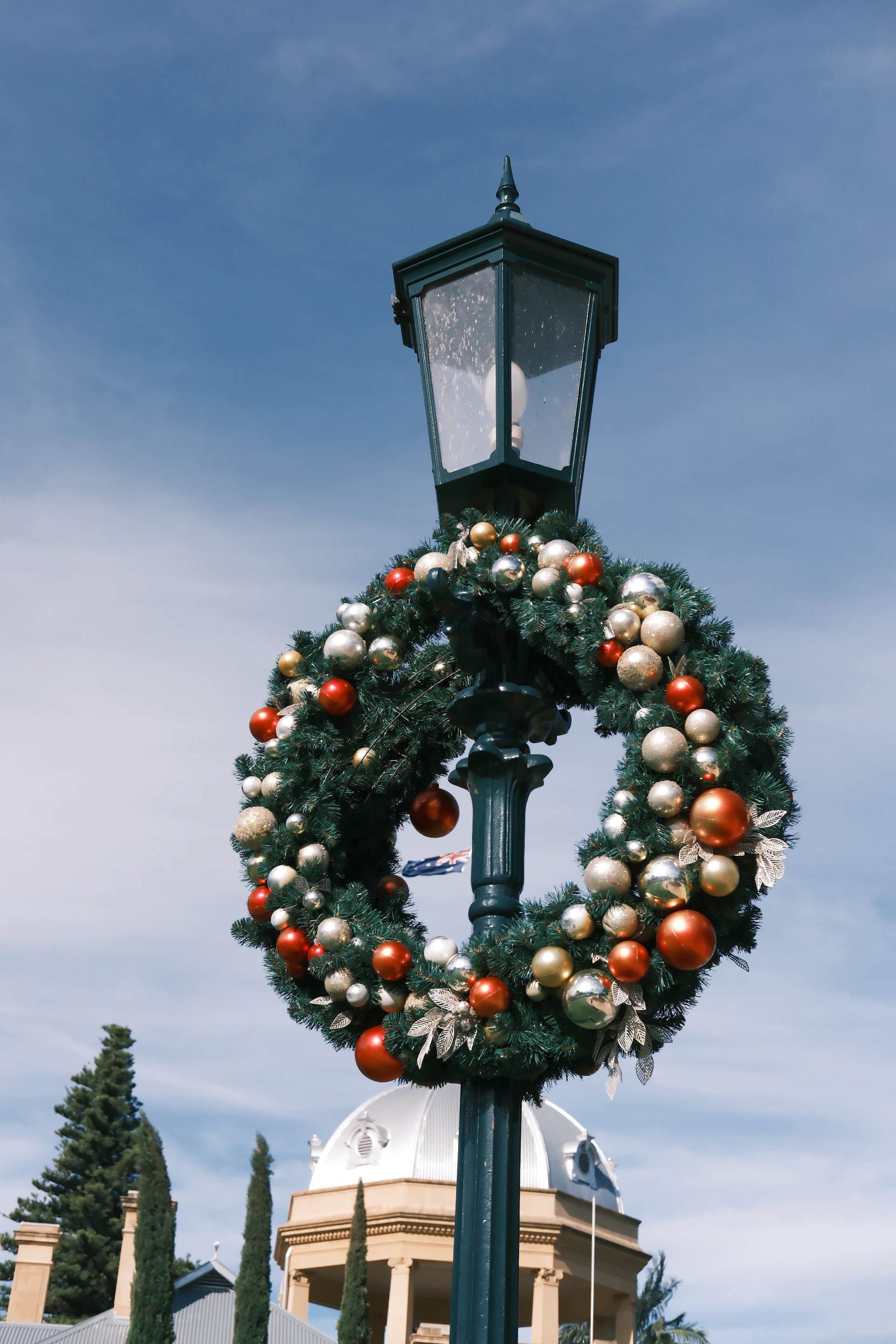 Christmas wreath with ornaments on a lamppost