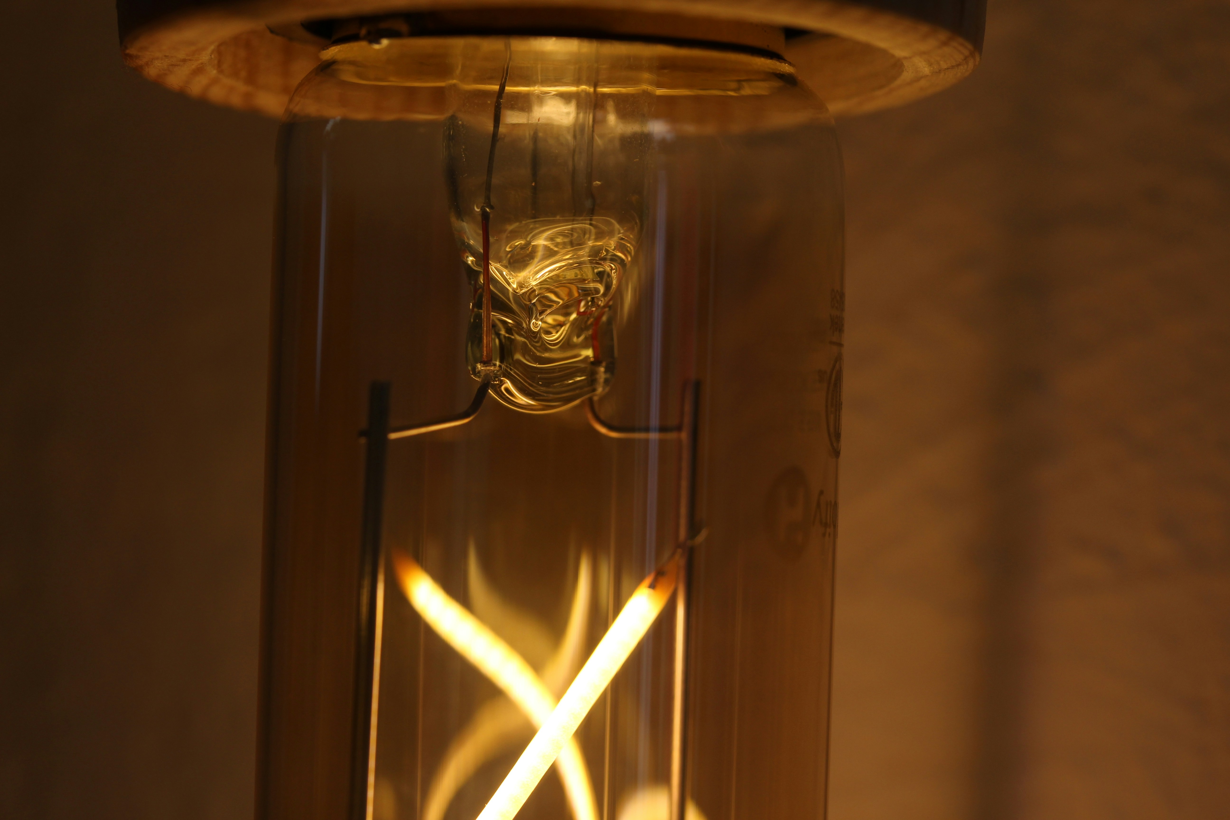 Close-up of a vintage edison light bulb filament glowing