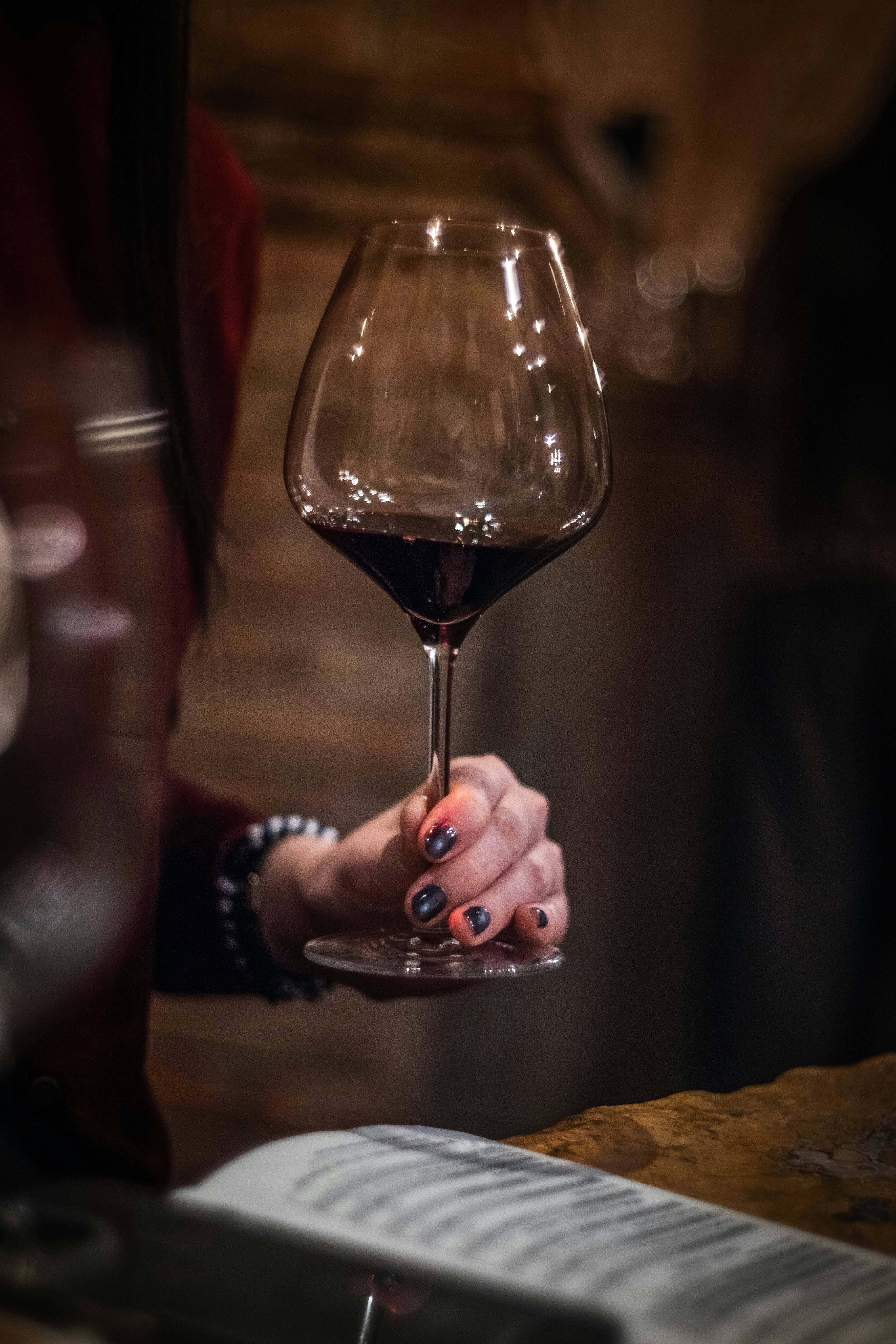 Hand holding a glass of red wine