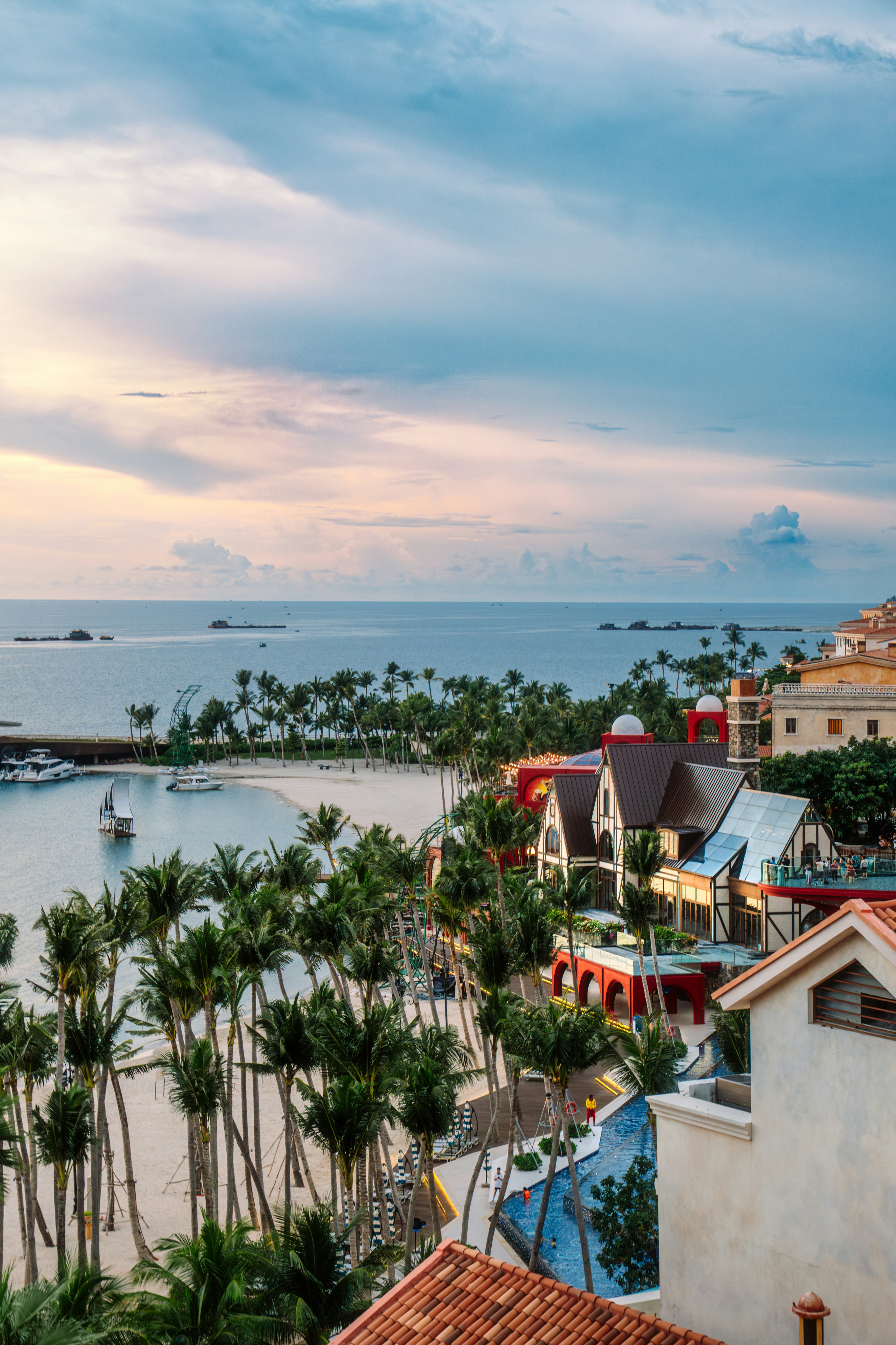 Tropical resort with palm trees and ocean view.