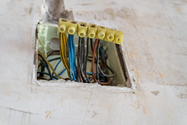 Electrical wires connected with yellow terminal blocks.