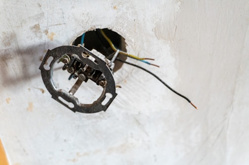 Exposed electrical wires and junction box on ceiling.