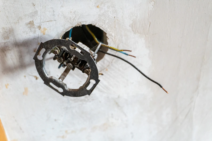 Electrician working on residential electrical wiring and a junction box