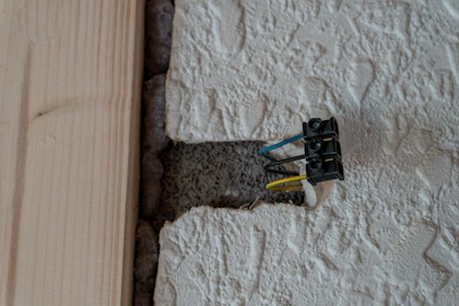 Exposed electrical wires in a textured wall opening
