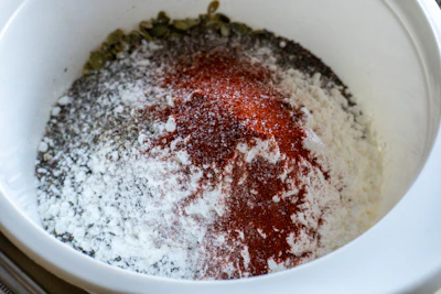 Spices and flour mixed in a white bowl.