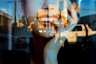 Double exposure of smiling mouth and truck