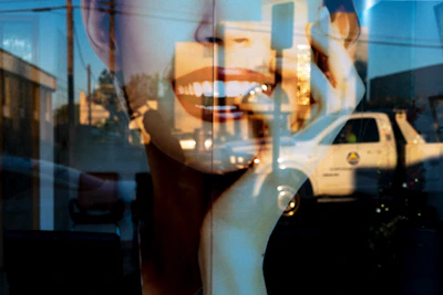Double exposure of smiling mouth and truck