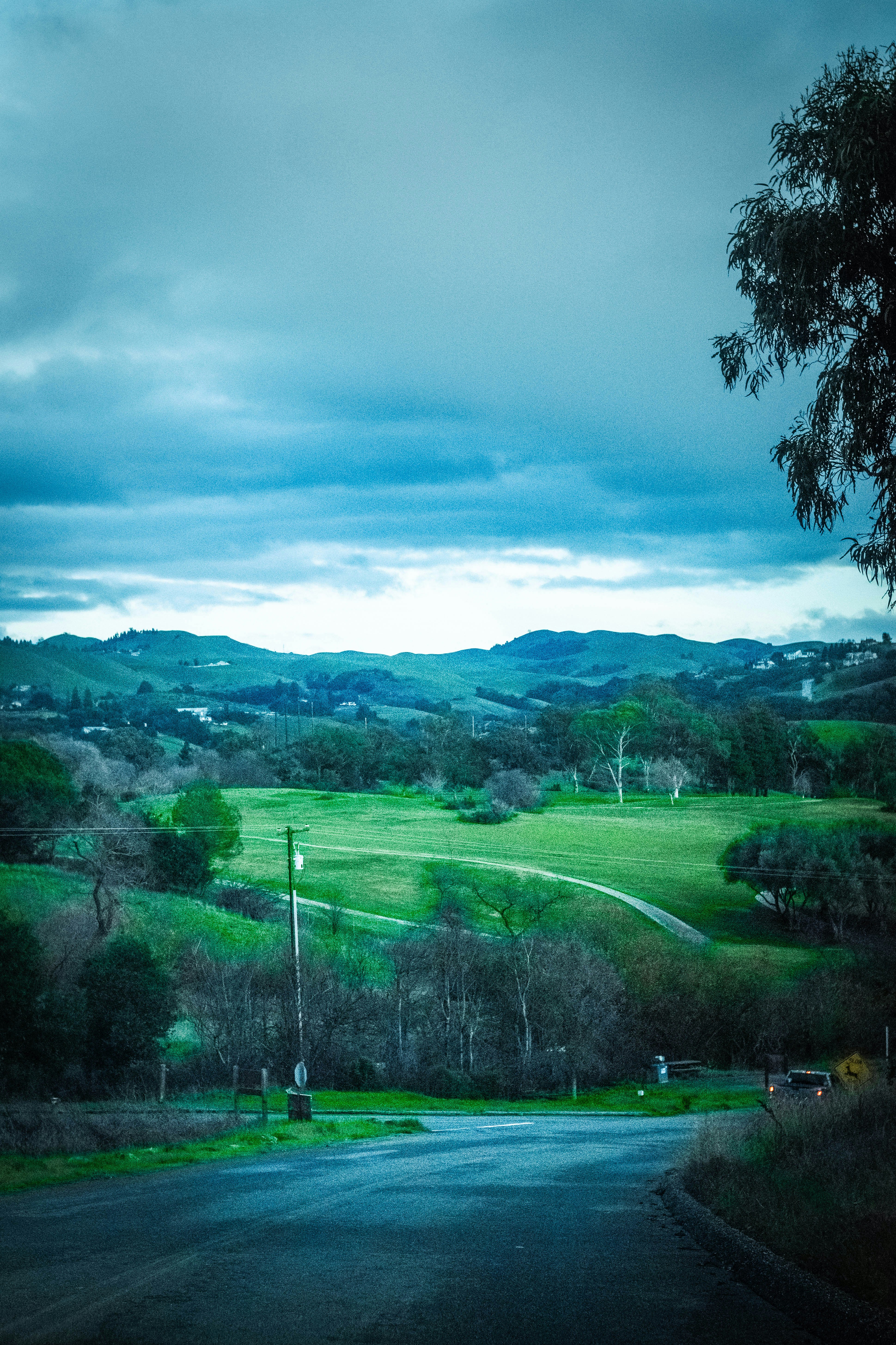 Rolling green hills under a cloudy sky.