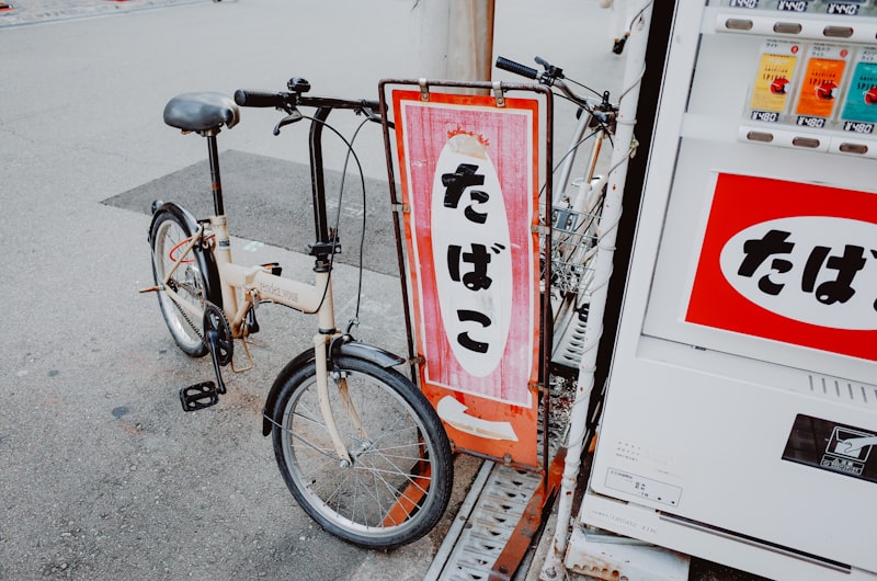 Folding bike parked next to vending machine