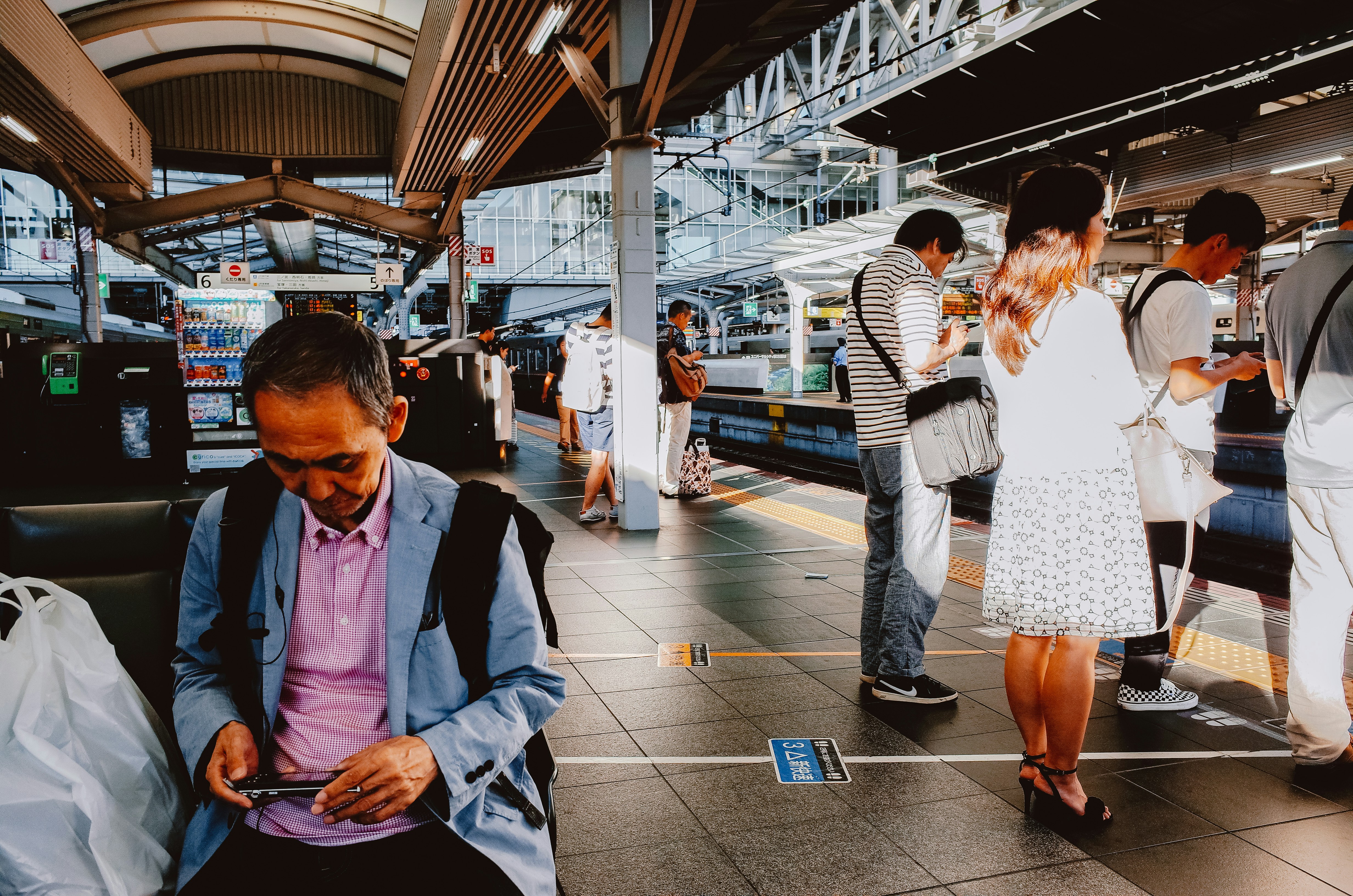 People waiting on a train station platform.
