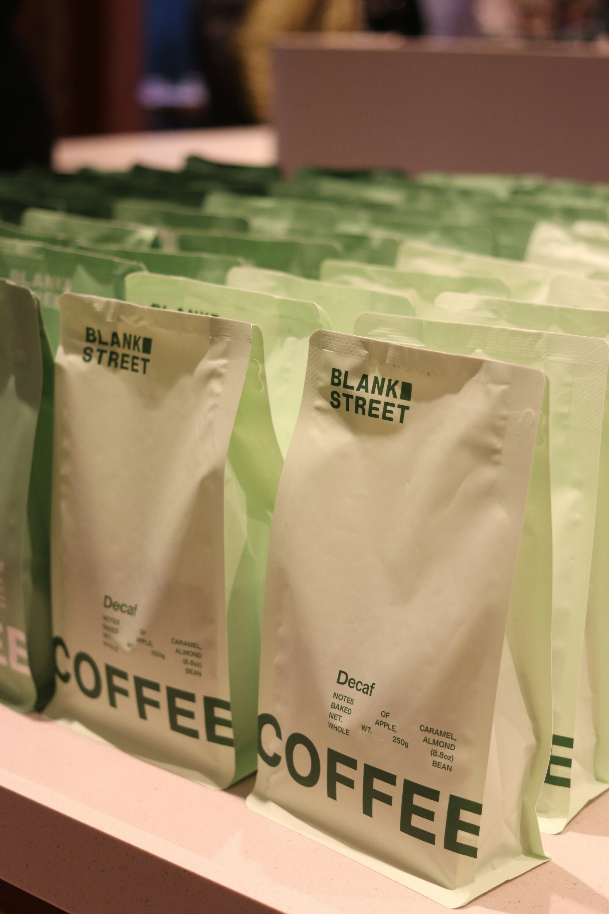 Rows of decaf coffee bags from blank street.