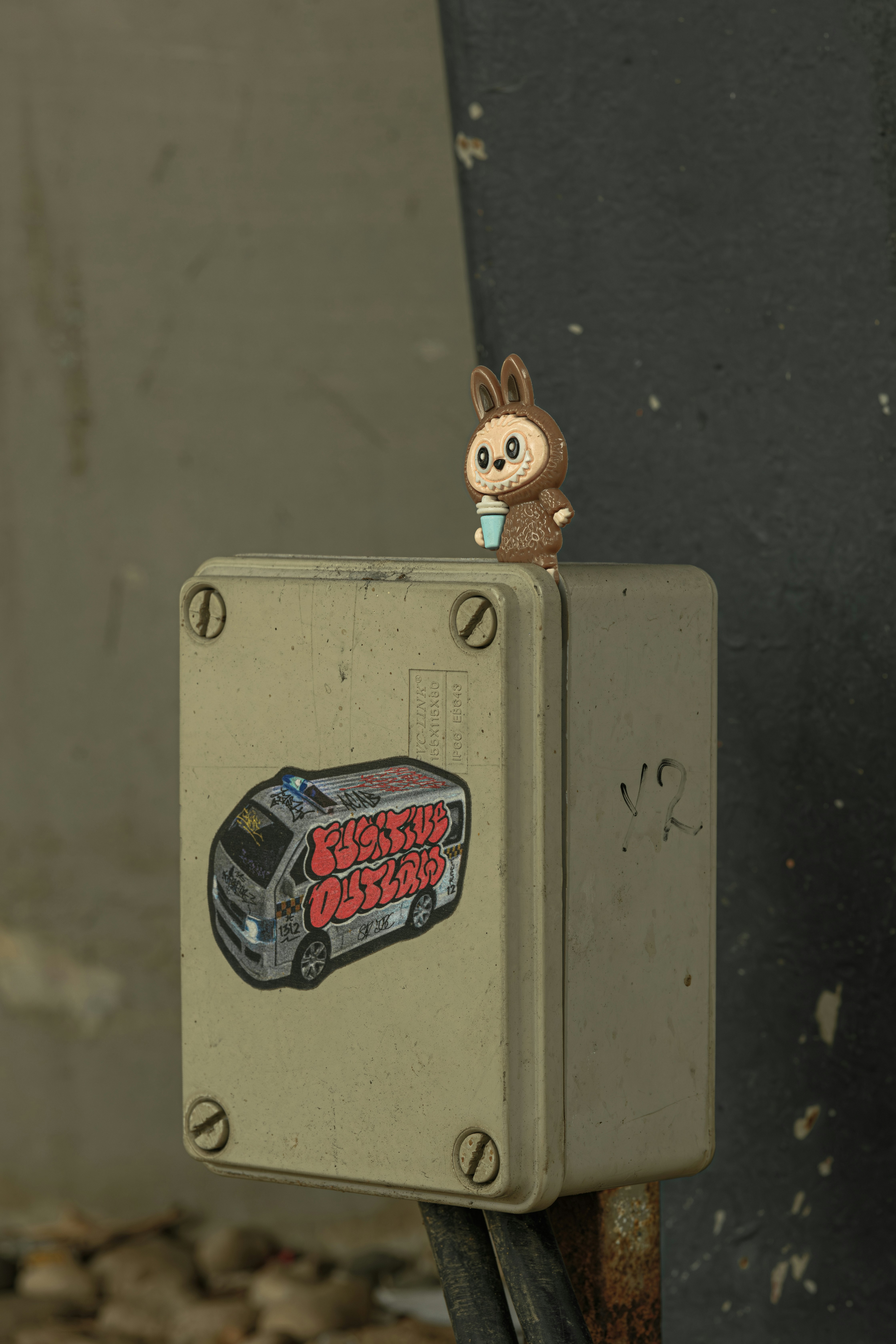 Small bunny figure on electrical box with sticker