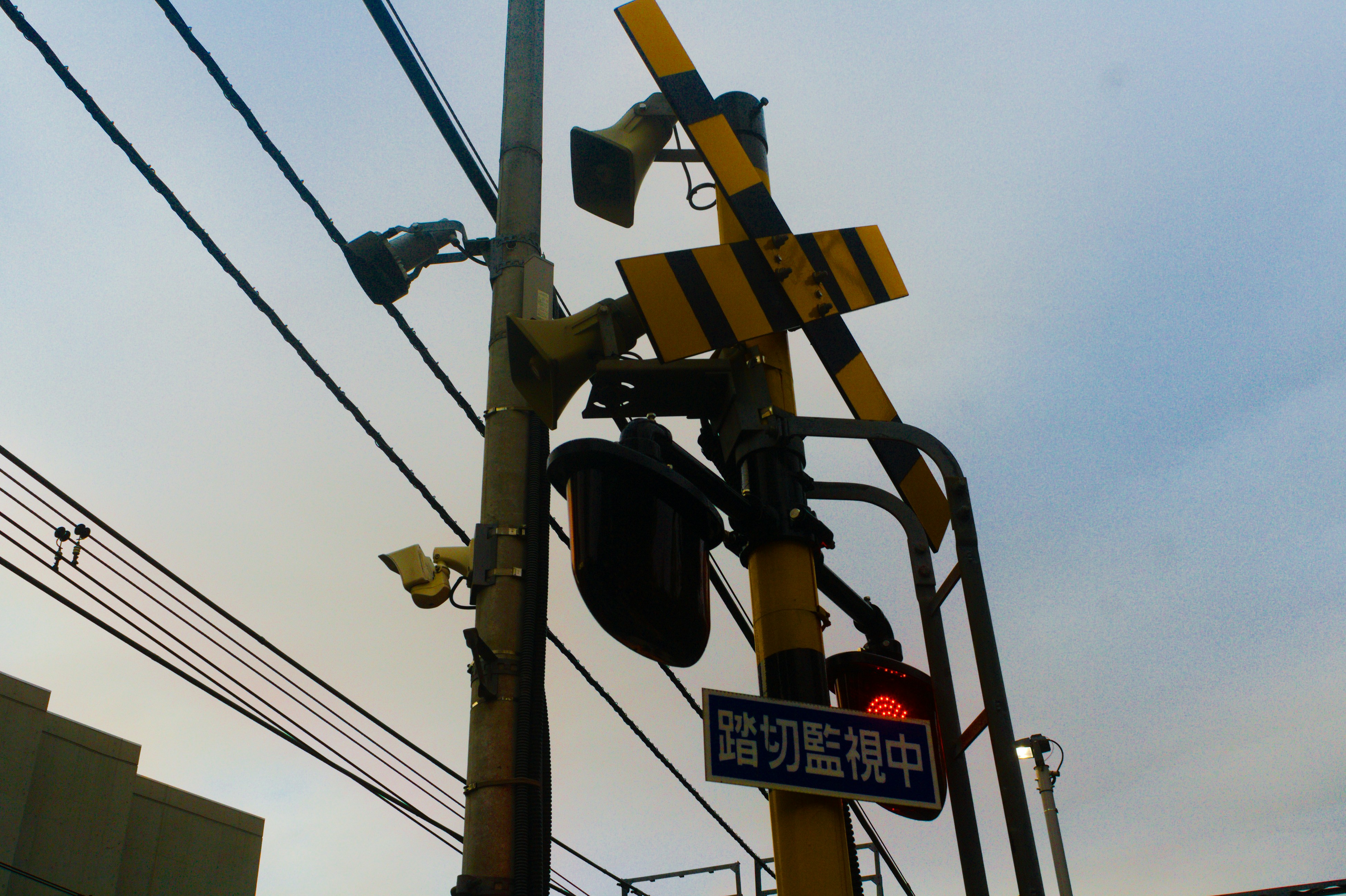 Railroad crossing signal with red light illuminated