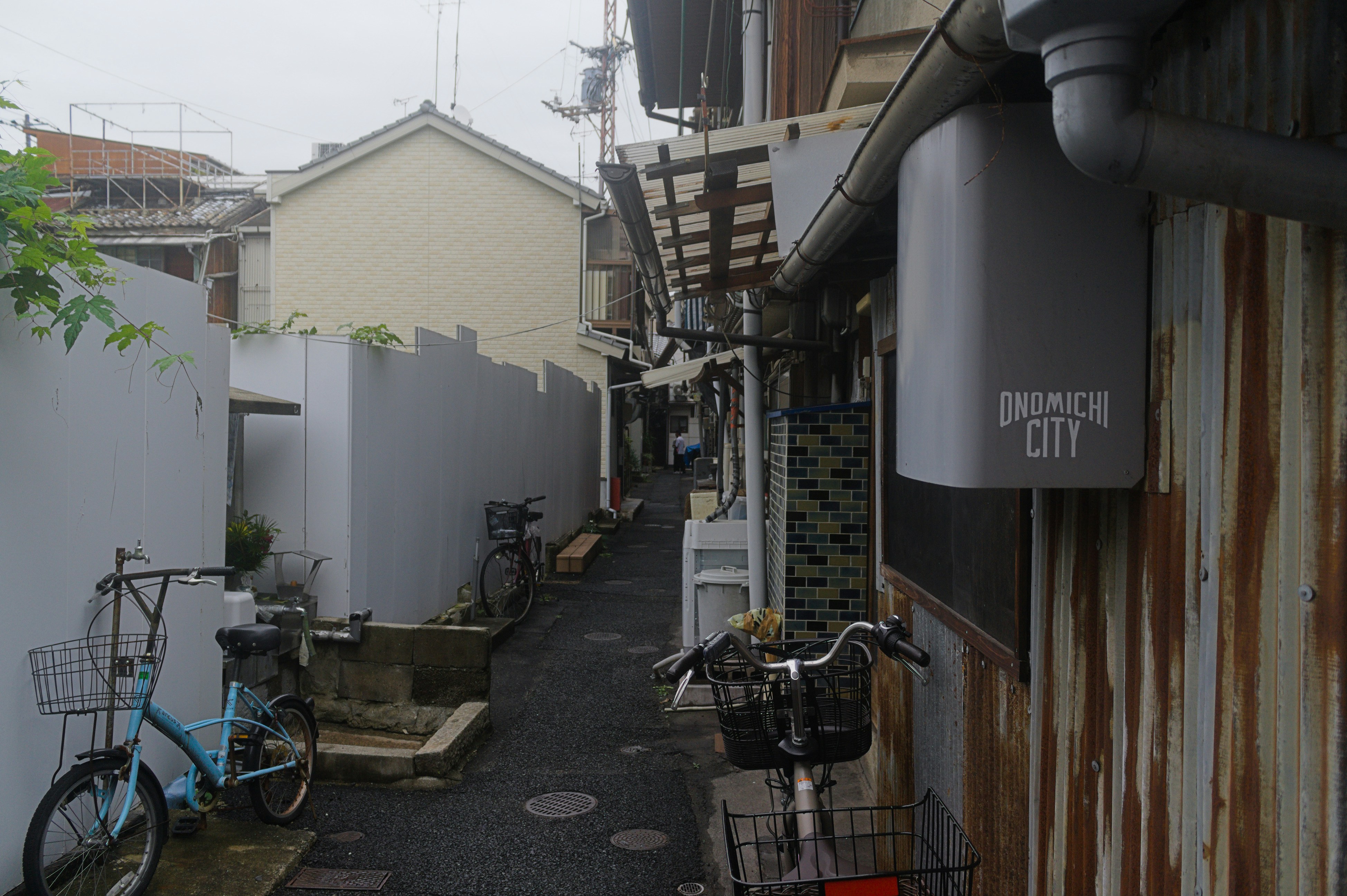 Narrow alleyway with bicycles and buildings.