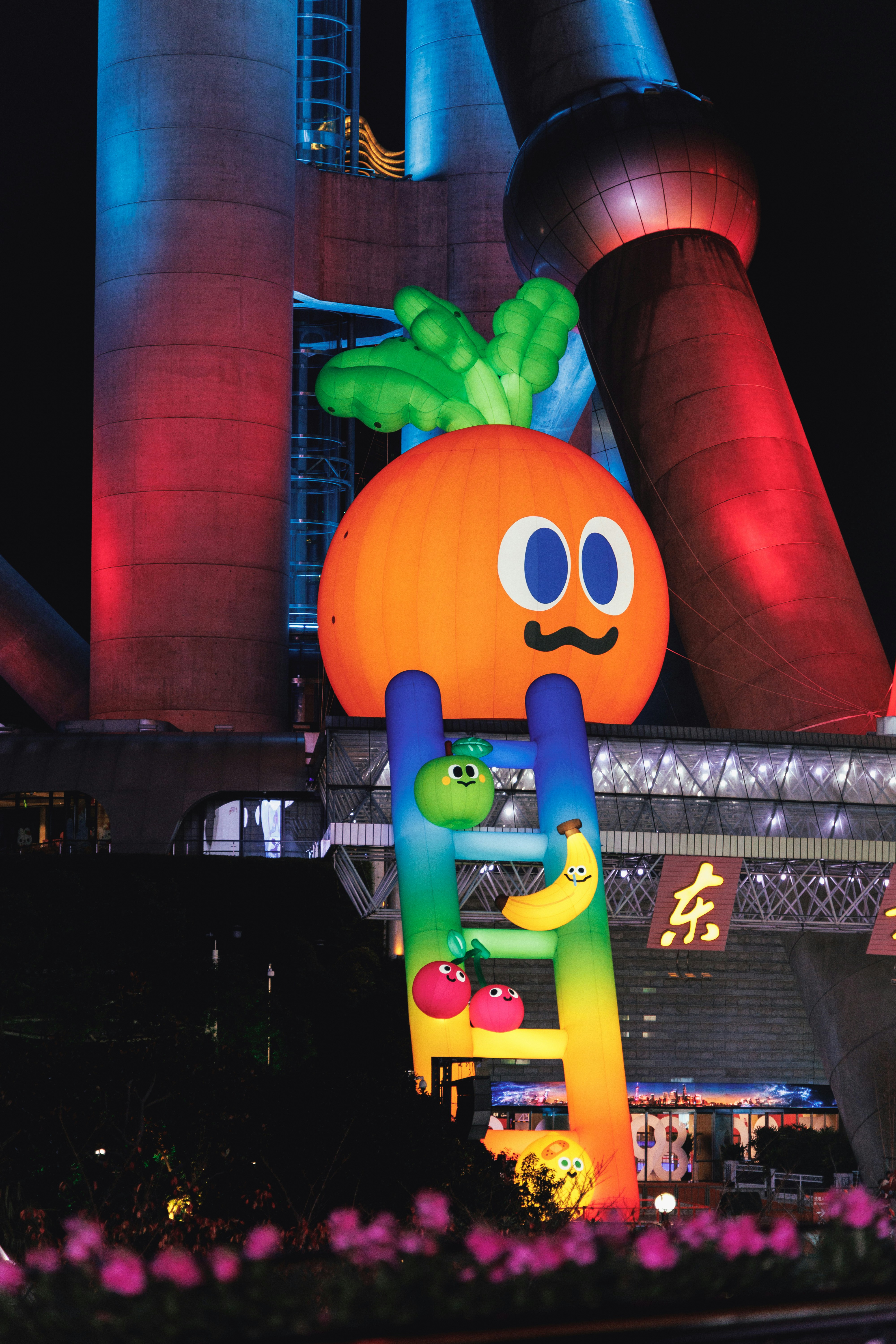 Giant inflatable carrot with smiling face on ladder