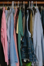 A closet full of neatly hung clothes.