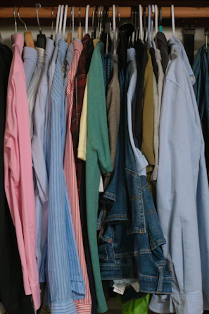 A closet full of neatly hung clothes.