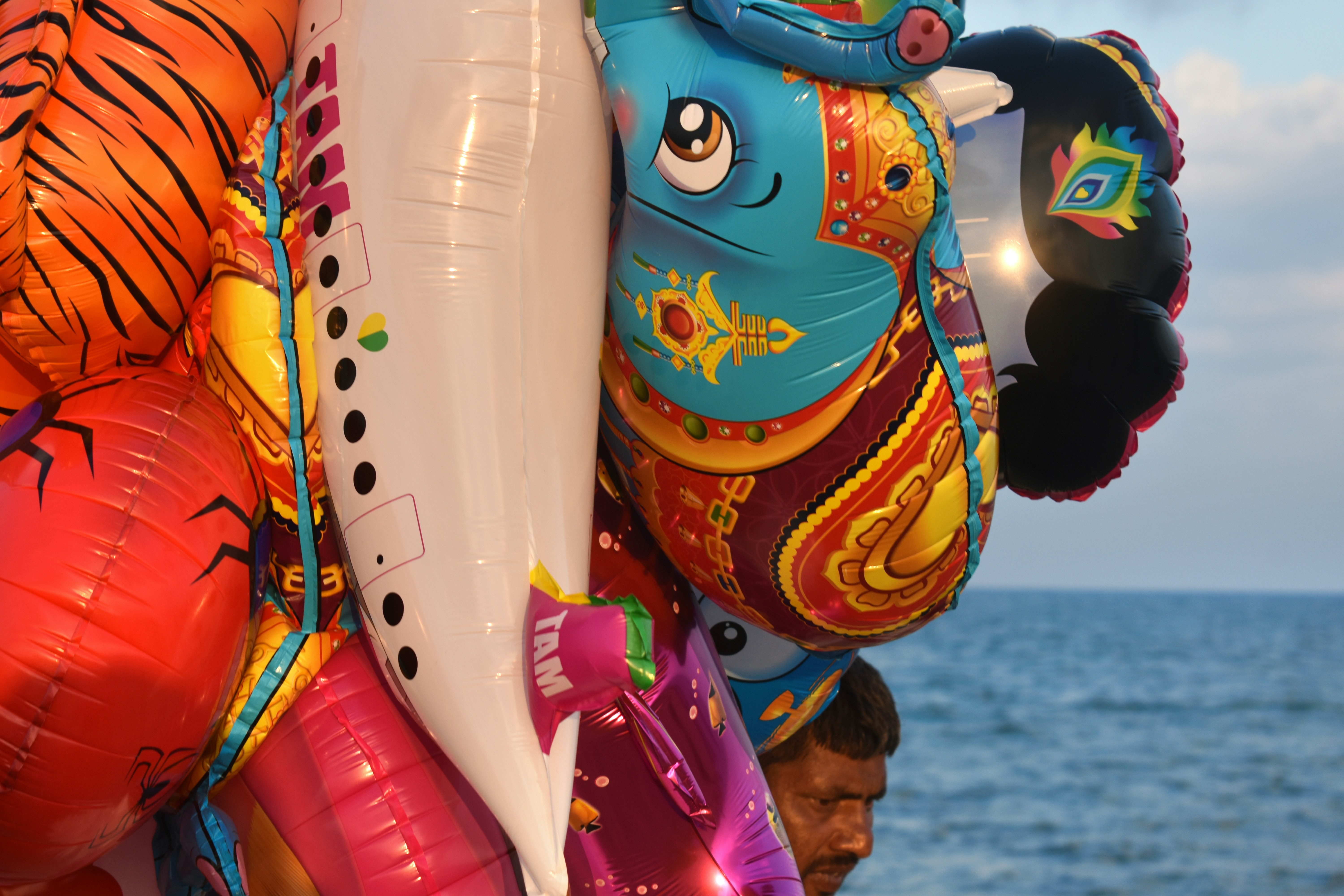 Colorful balloons with a man in the background