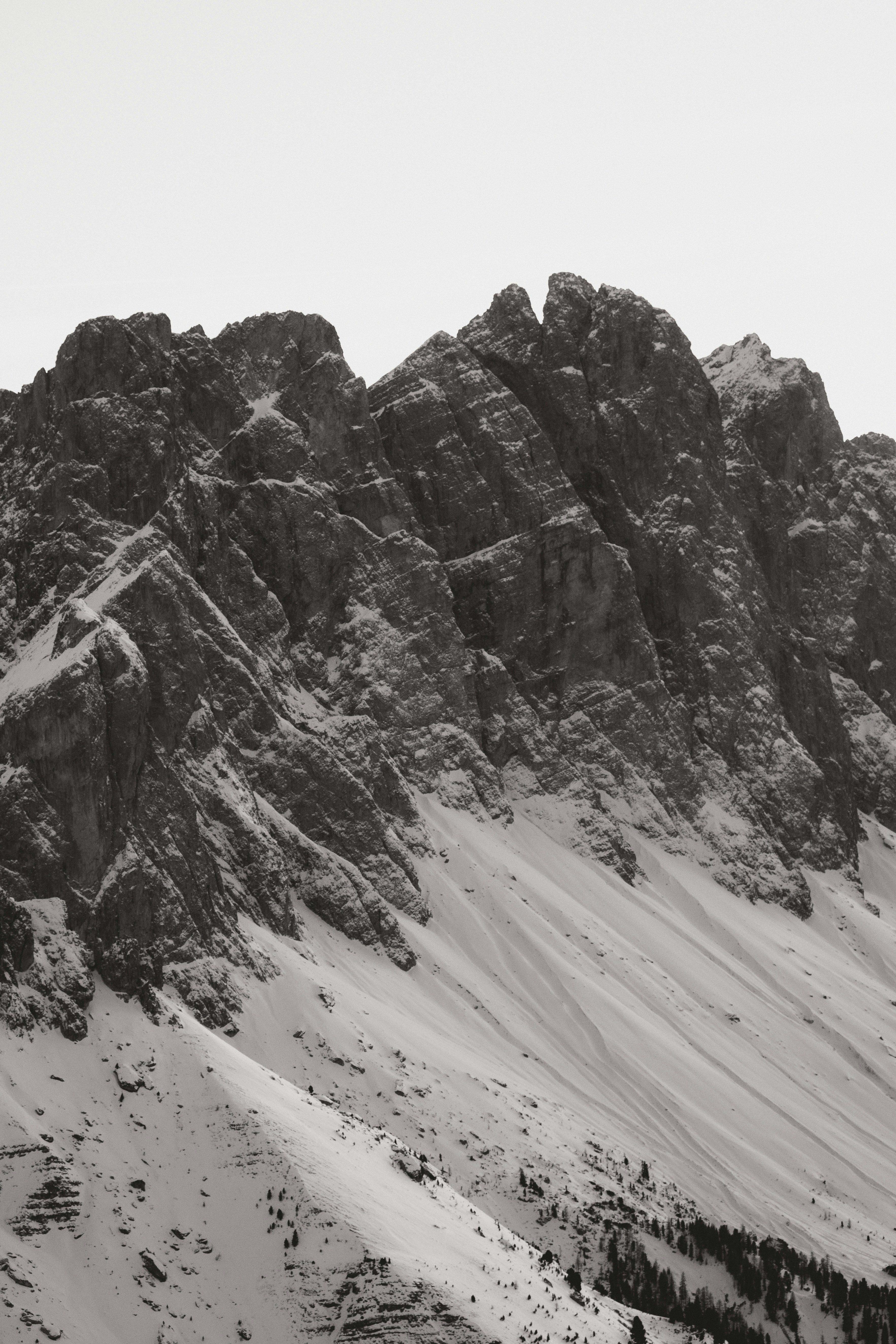 Snow covered mountain range under a cloudy sky