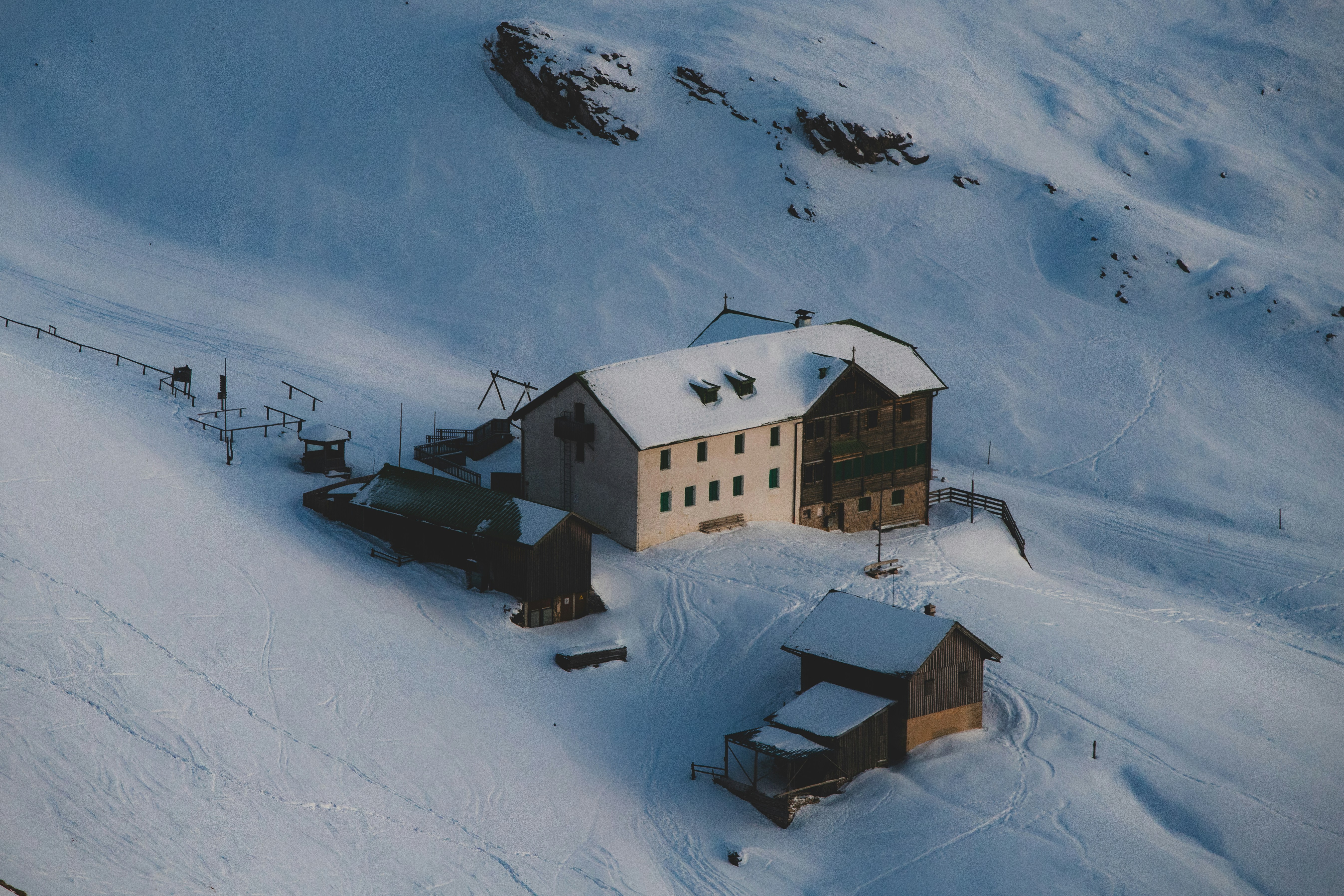 Mountain lodge nestled in a snowy alpine landscape.