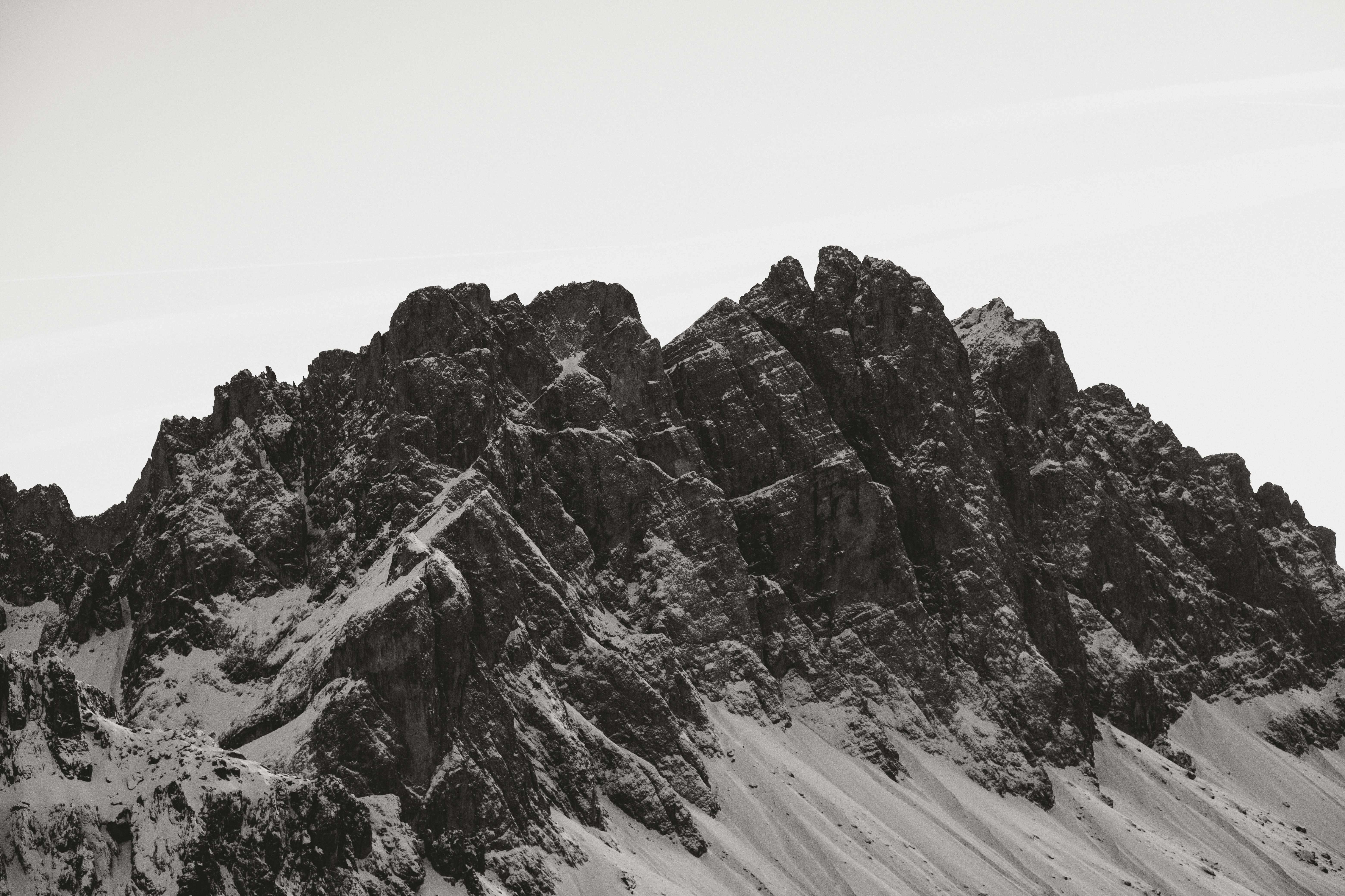 Jagged snow-covered mountain peaks under a clear sky