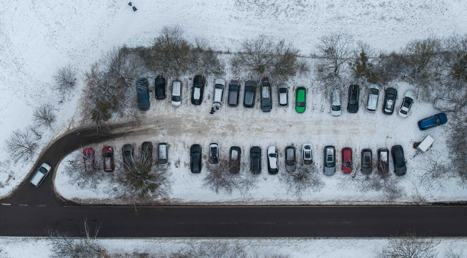 A snow covered parking lot seen from above