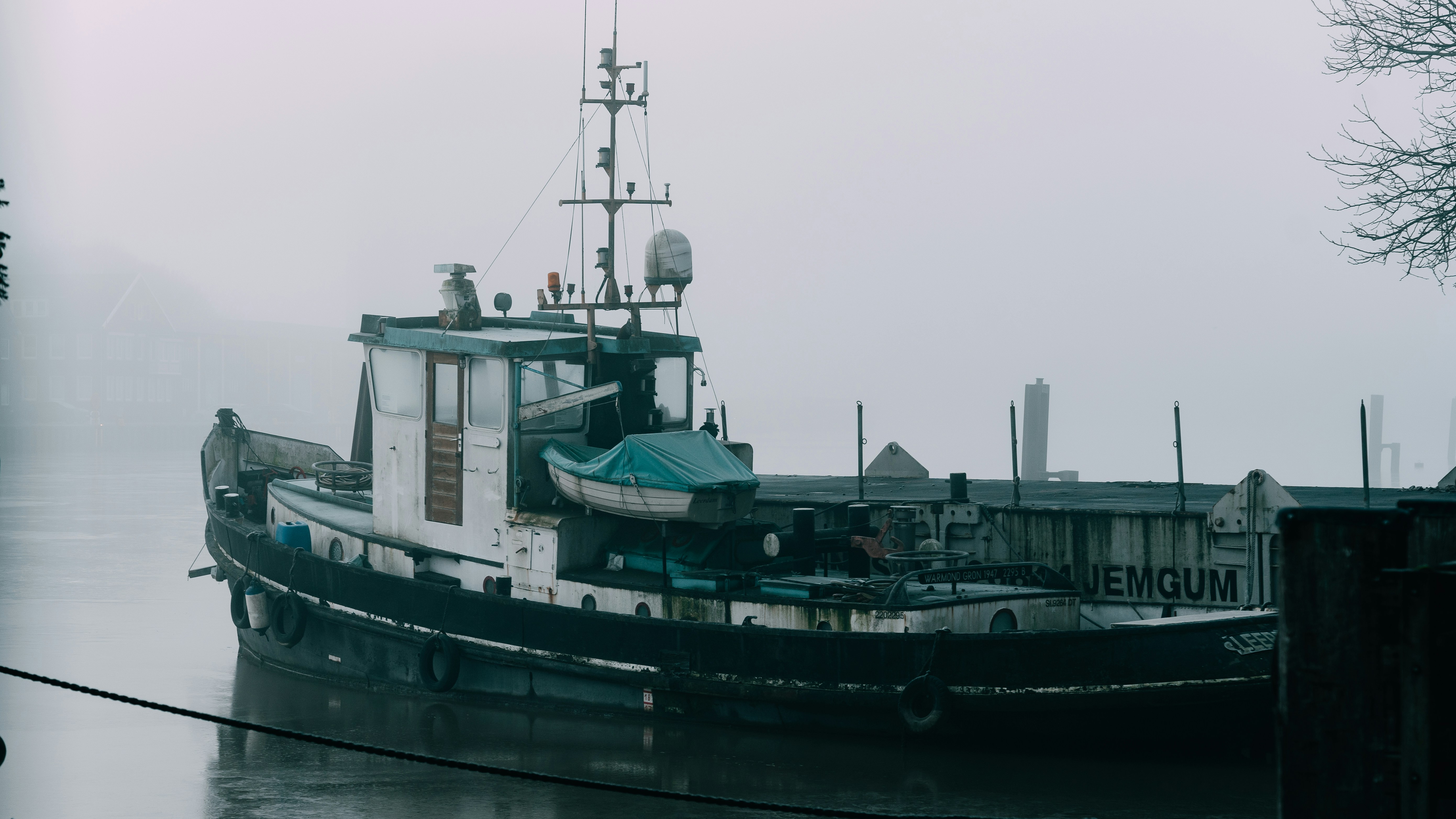 Tugboat docked on a foggy day