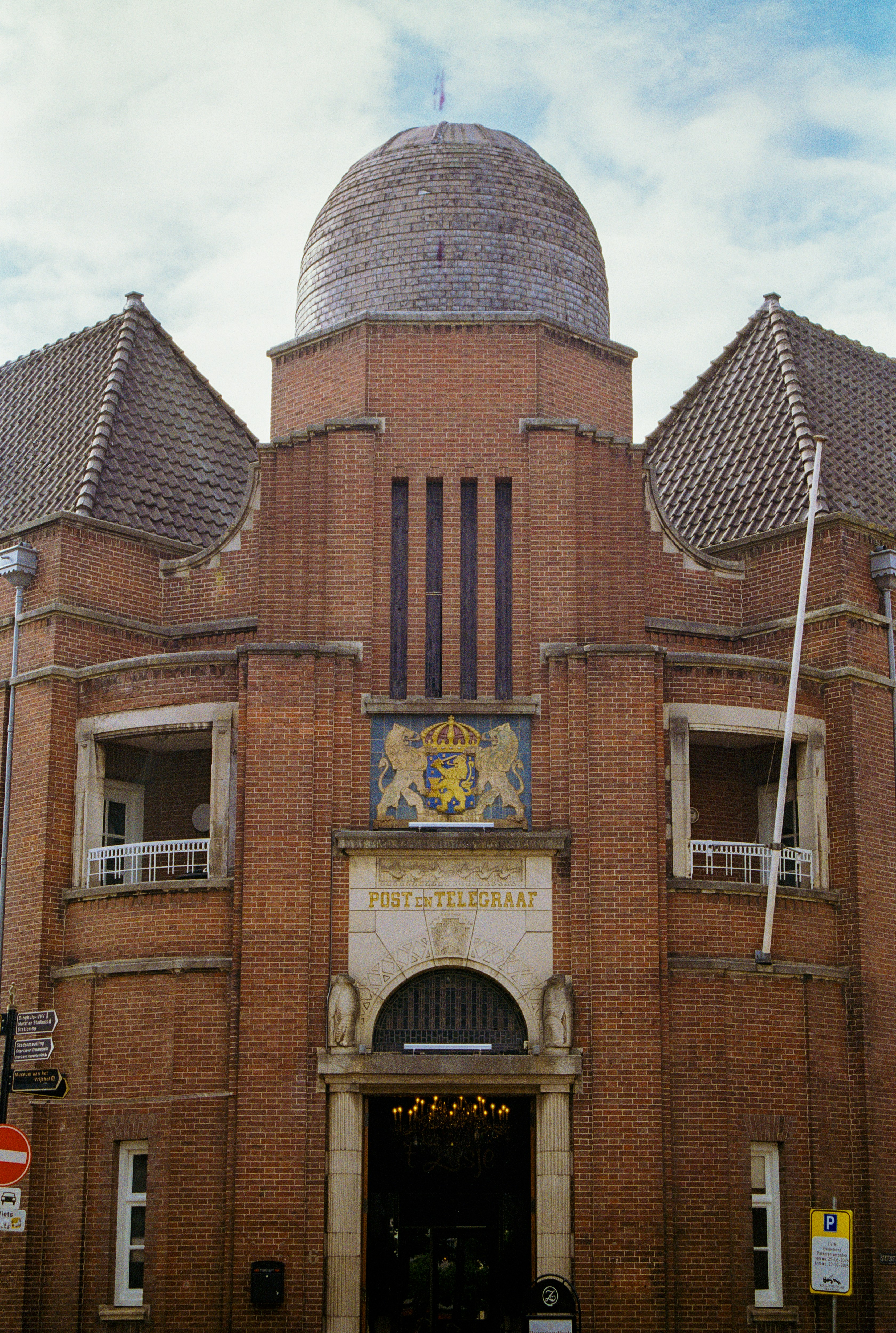 Ornate brick building with a dome and crest