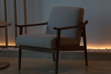 A modern armchair in a dimly lit room.