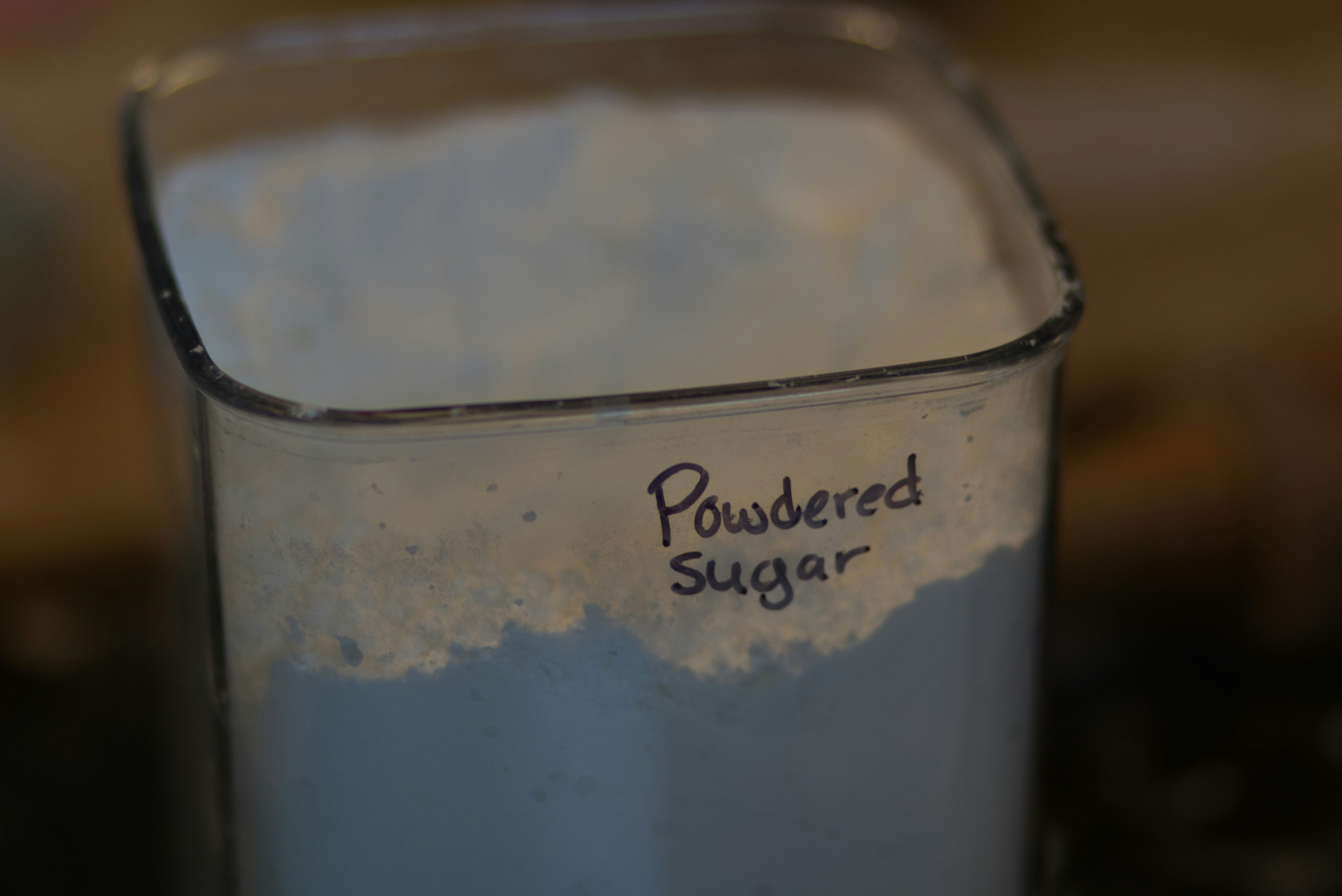 Container of powdered sugar with label.