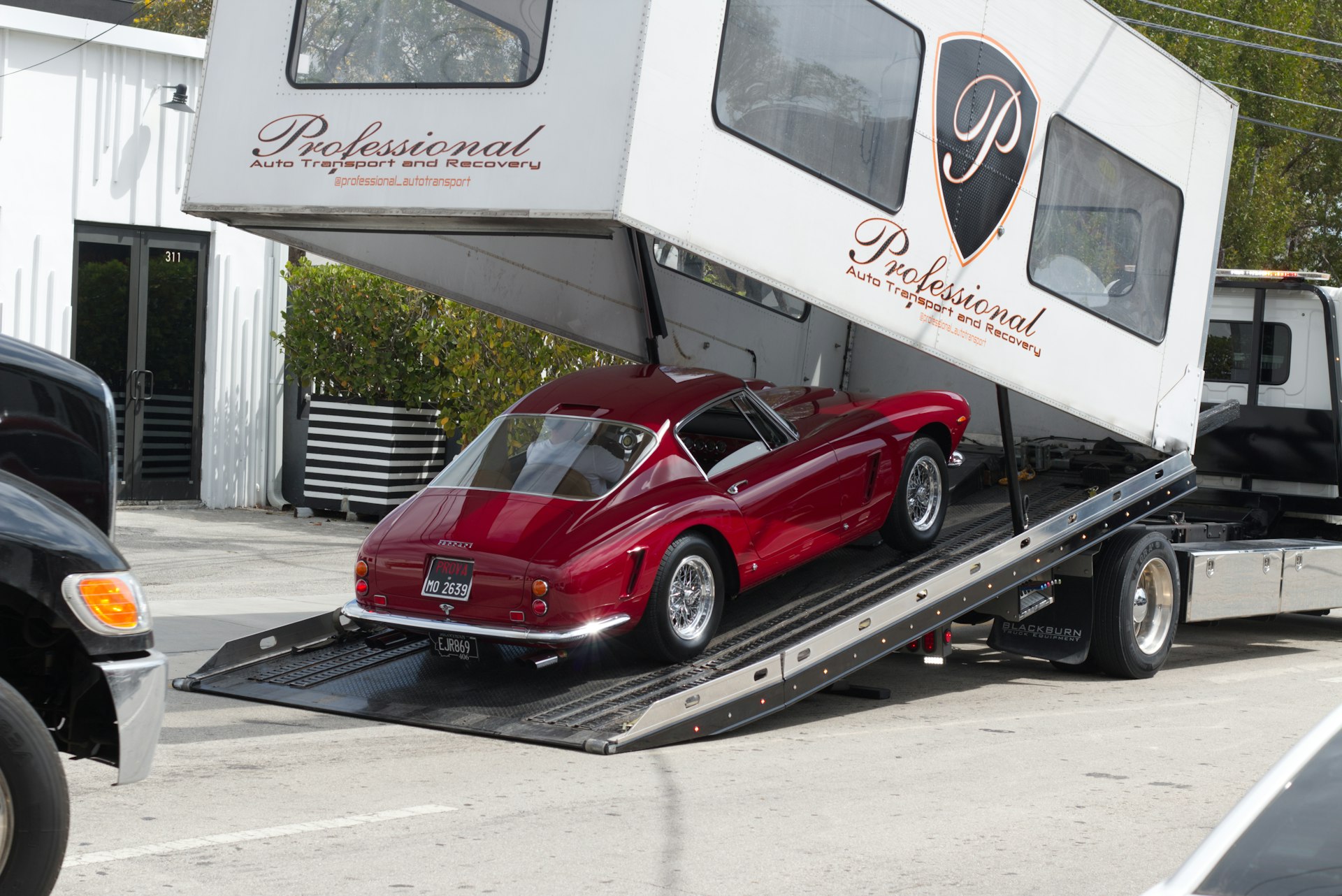 Car being loaded onto a car hauler trailer