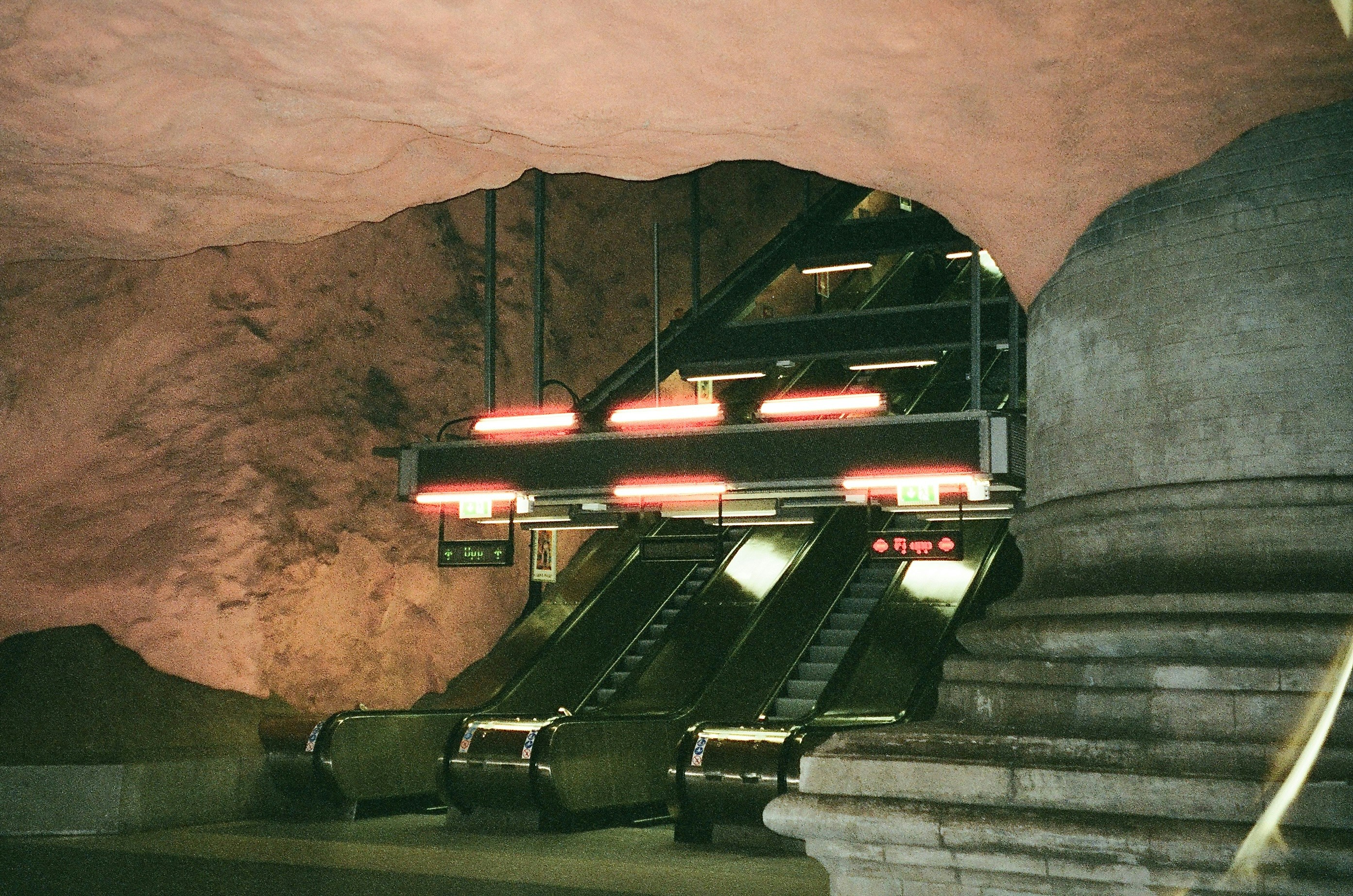 Escalators in a cave-like subway station.