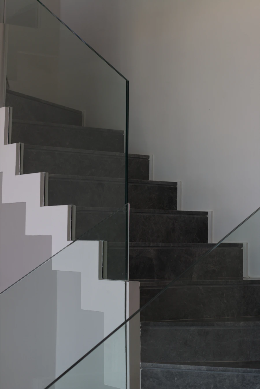 Minimal glass railing along a modern residential staircase