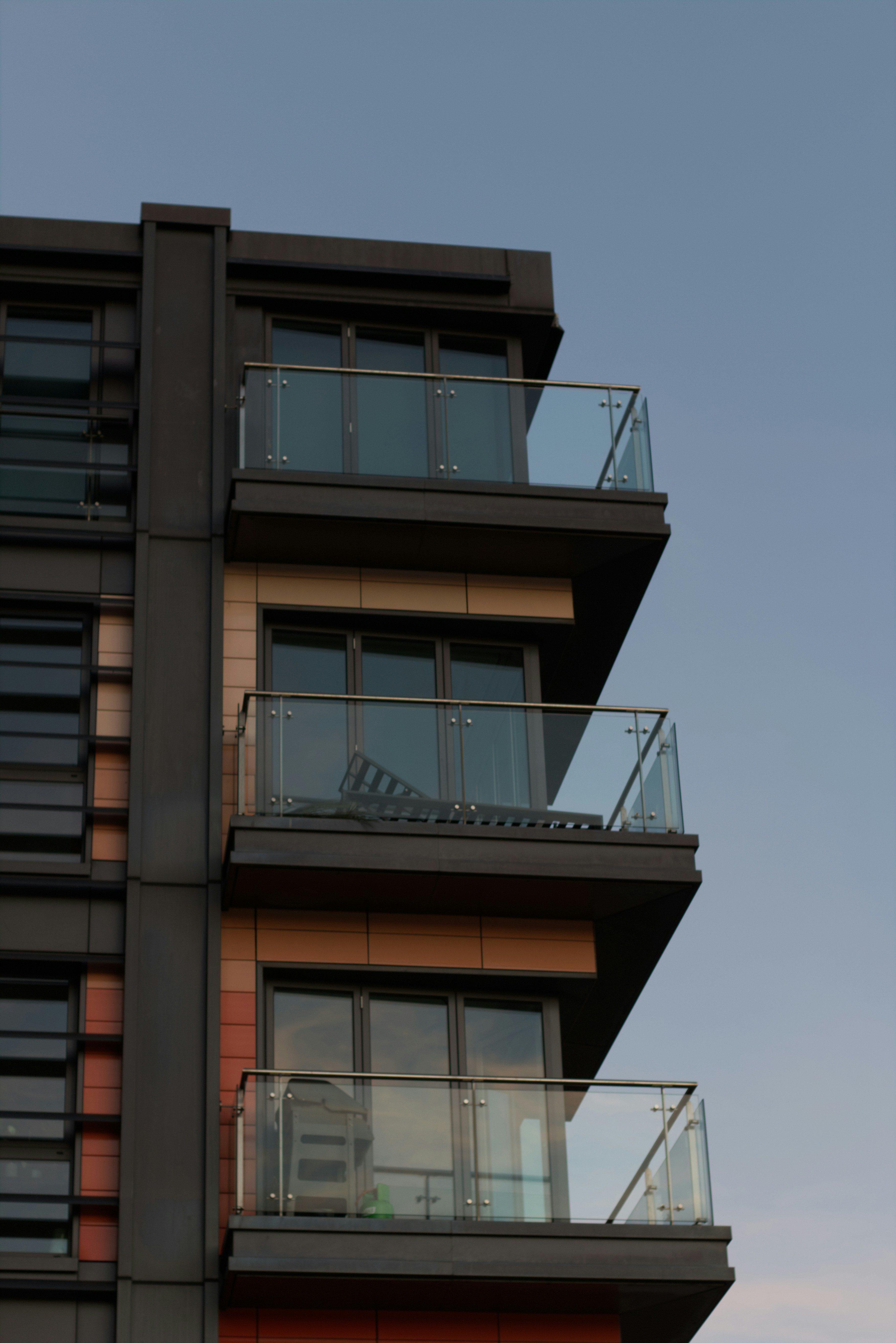 Modern apartment building with balconies against sky