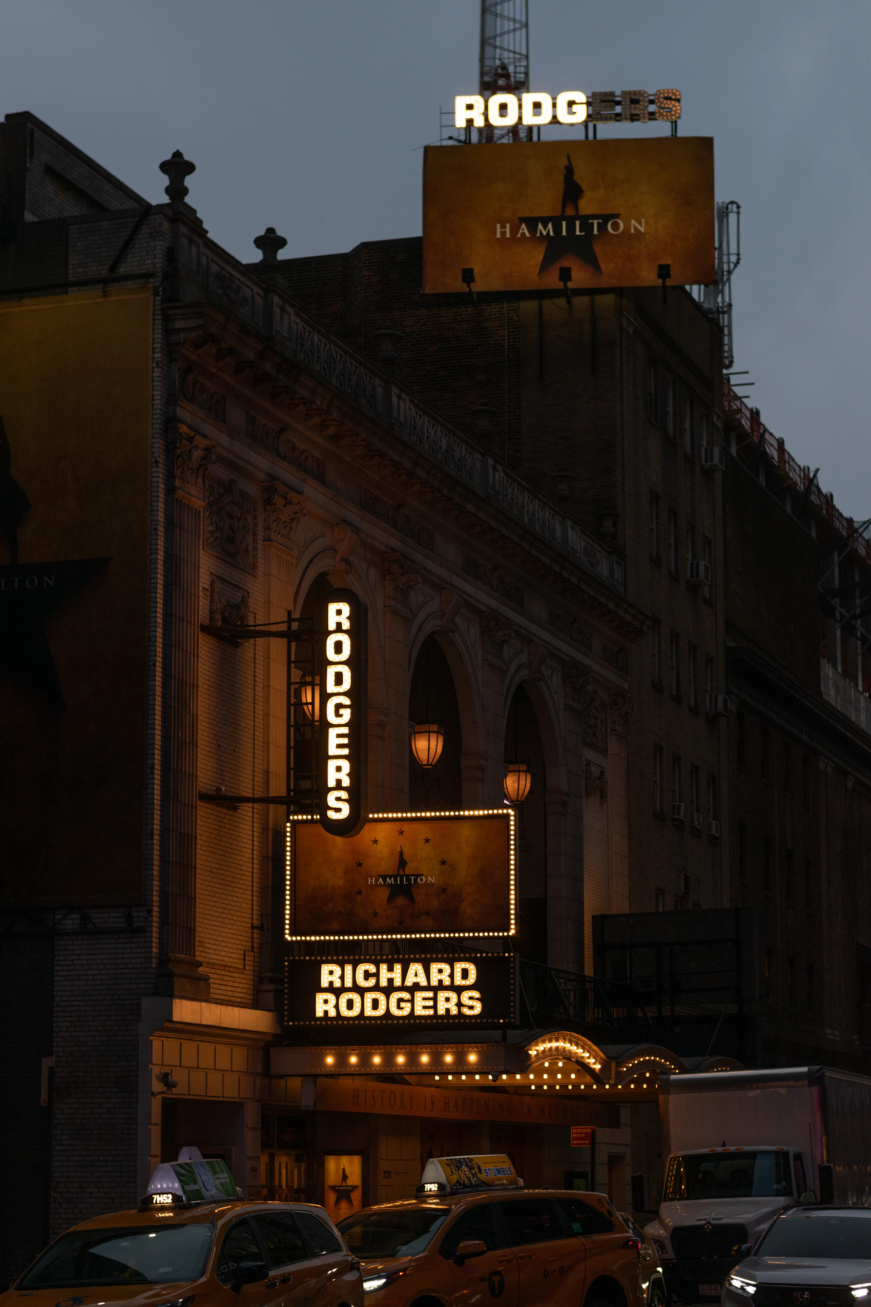 The illuminated Richard Rodgers Theatre and Hamilton marquee at dusk in New York