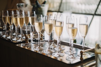 Champagne flutes filled with bubbly liquid on tray