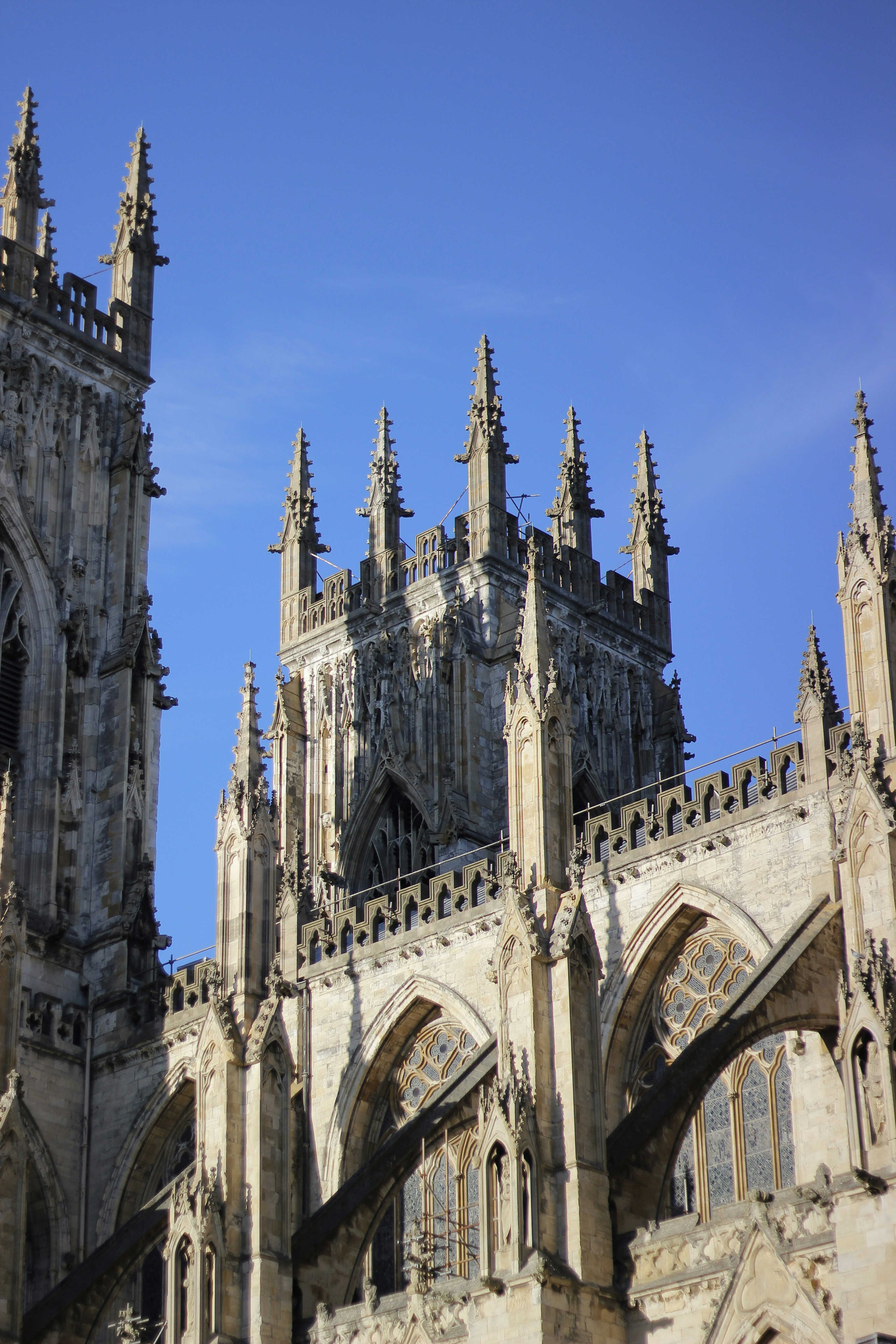 Gothic cathedral architecture against a clear blue sky.