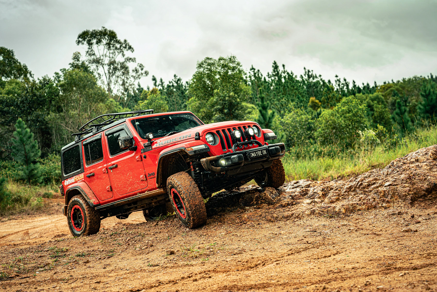 Lifted off-road 4x4 truck climbing a rocky trail, showing the kind of terrain where 4WD and AWD systems behave very differently