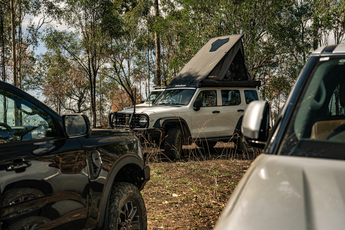 Replaceable photograph of a 4WD touring campsite with a rooftop tent in bushland