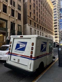 Usps mail truck parked on a city street