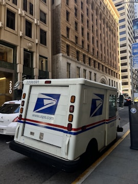 Usps mail truck parked on a city street