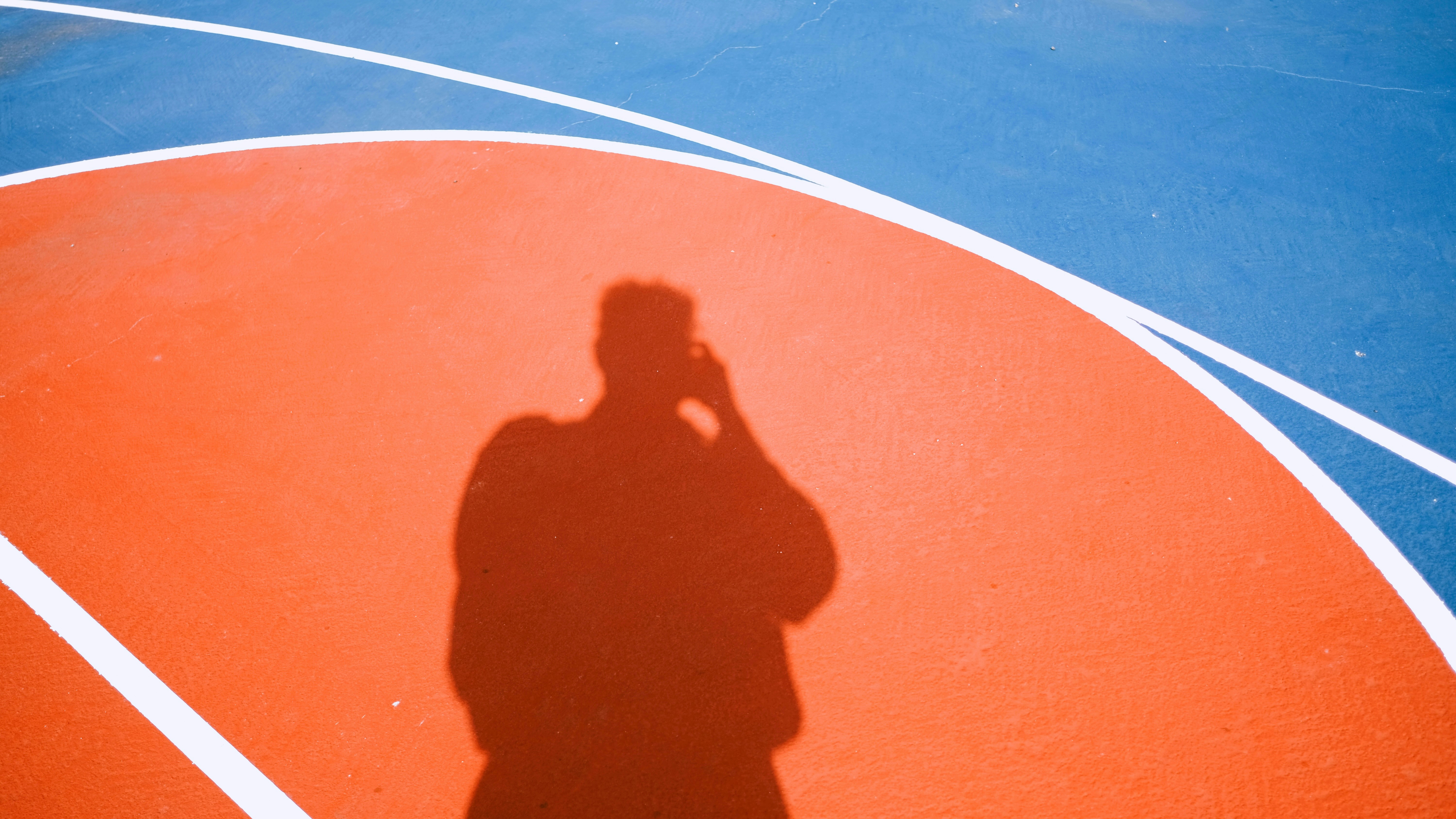 Shadow of a person on a basketball court