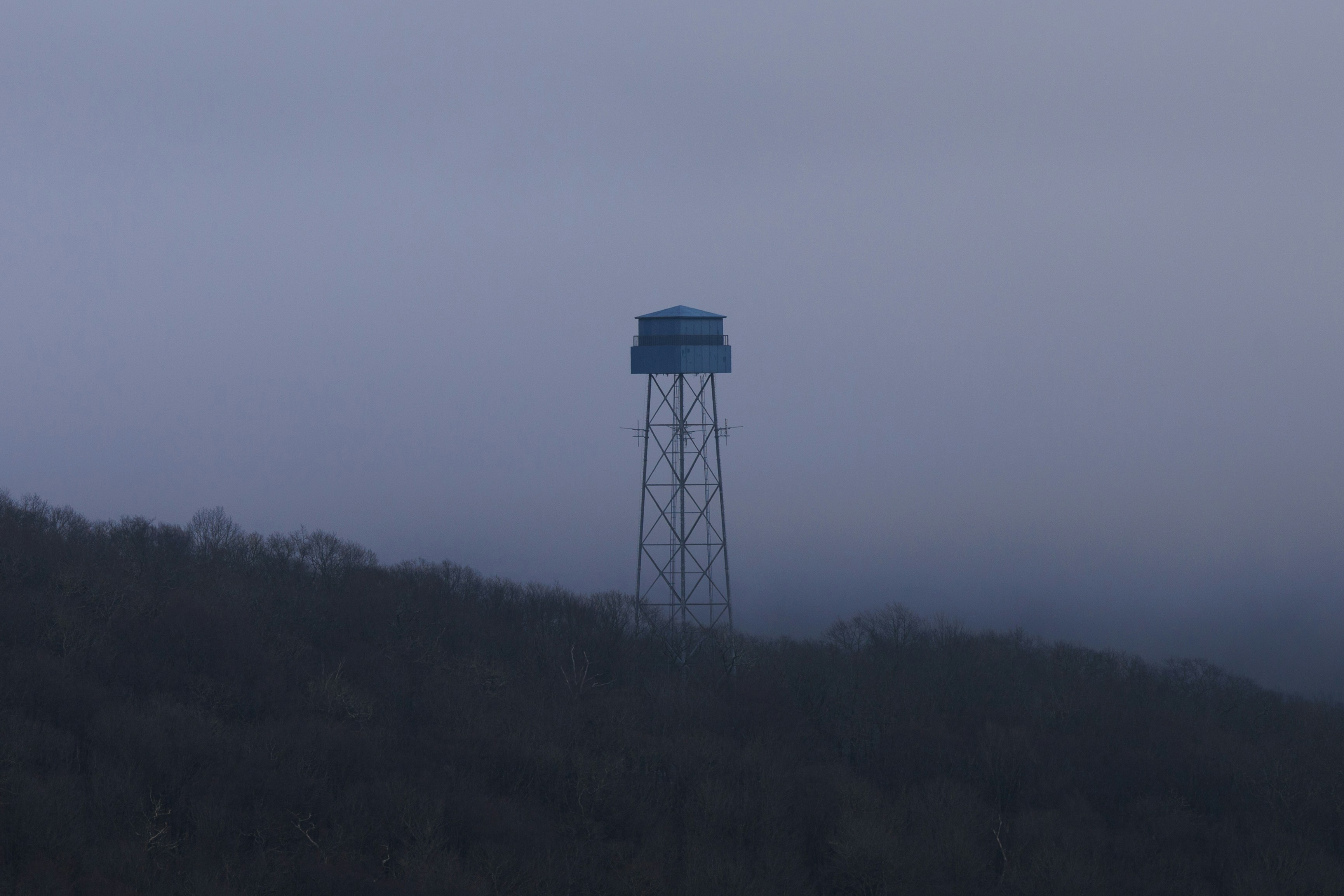 Water tower on a hill at dusk