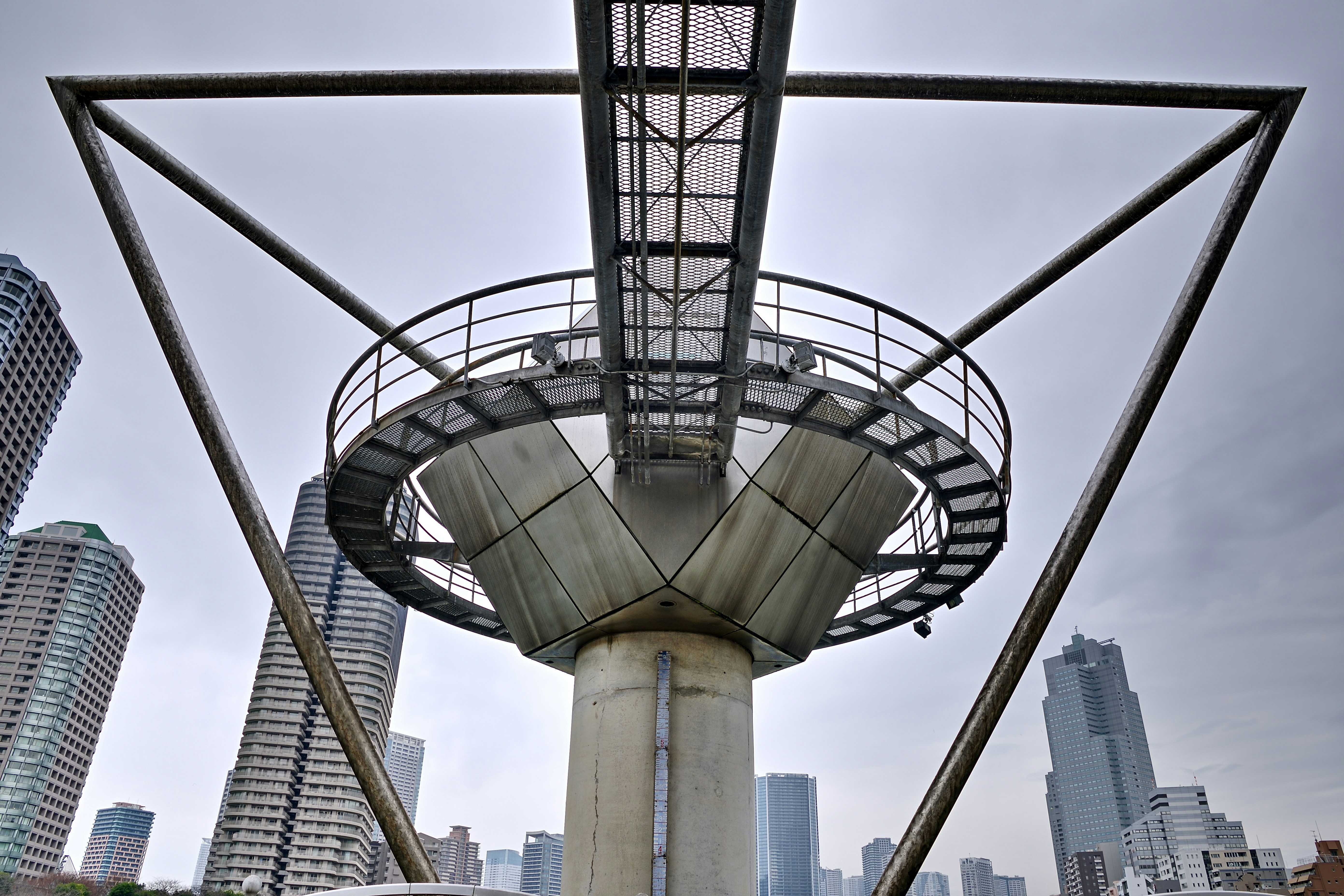 Futuristic observation tower with city buildings